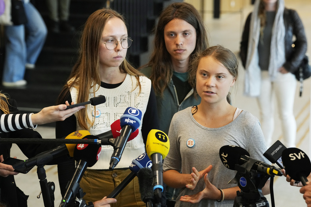 Climate activists Greta Thunberg, right, Elvin Landaeus Csizmadia, centre, and Irma Kjellstrom, speak to the media after a hearing in a court in Malmo, Sweden, Monday, July 24, 2023. Thunberg was found guilty for disobeying a police order and sentenced to a thirty day fine. (AP Photo/Pavel Golovkin)