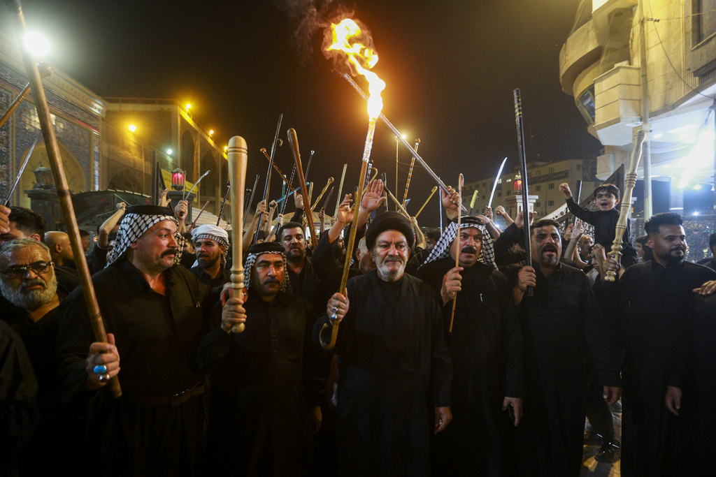 Shiites participate in Muharram processions in the Imam Ali shrine in Najaf, Iraq, Wednesday, July 26, 2023. During Muharram, Islam's second holiest month, Shiites mark the death of Hussein, the grandson of the Prophet Muhammad, at the Battle of Karbala in present-day Iraq in the 7th century. (AP Photo/Anmar Khalil)