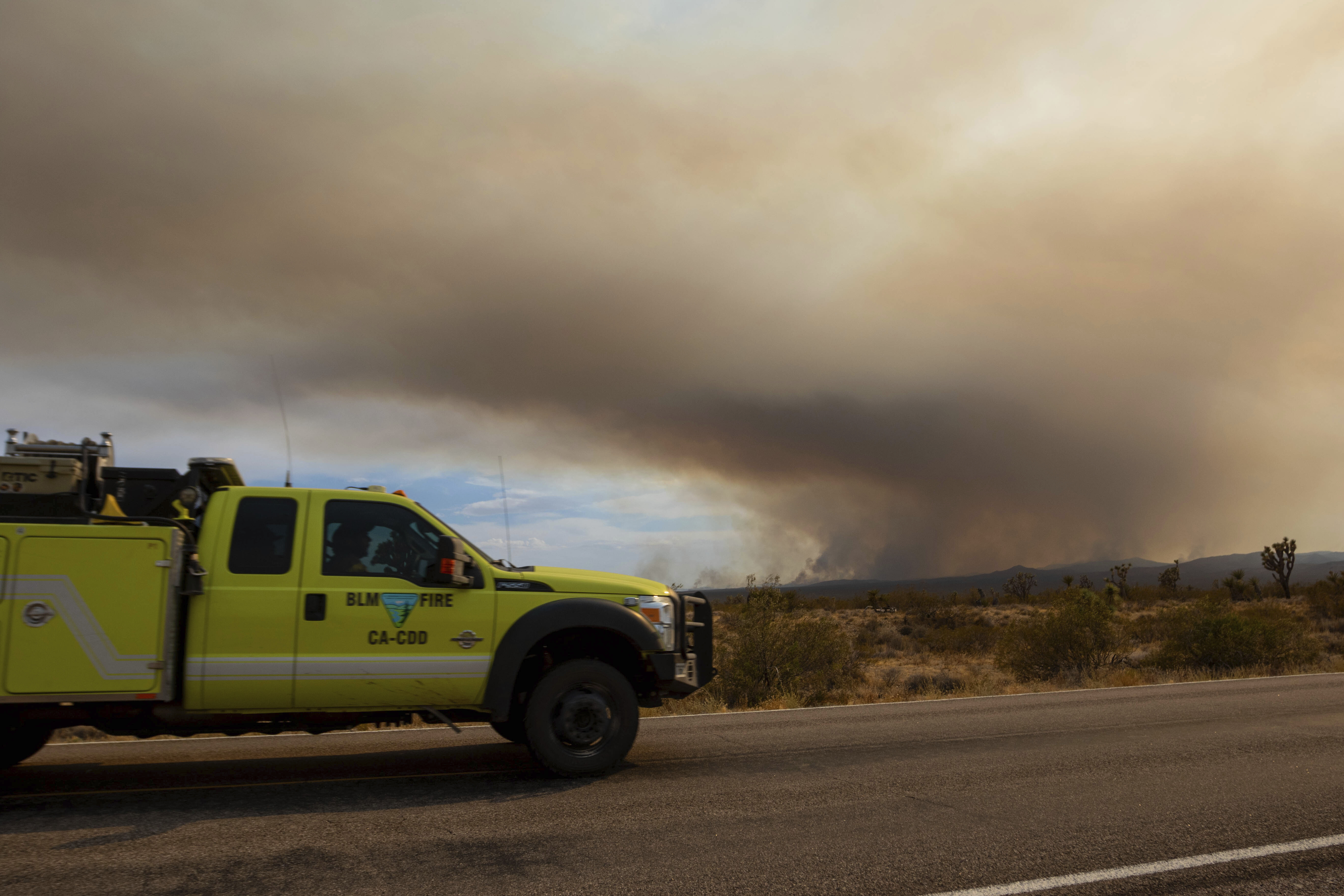 A fire truck heading towards the York Fire on Sunday, July 30, 2023, in the Mojave National Preserve, Calif. The York Fire has burned over 77,000 acres and has 0% containment. (AP Photo/Ty ONeil)