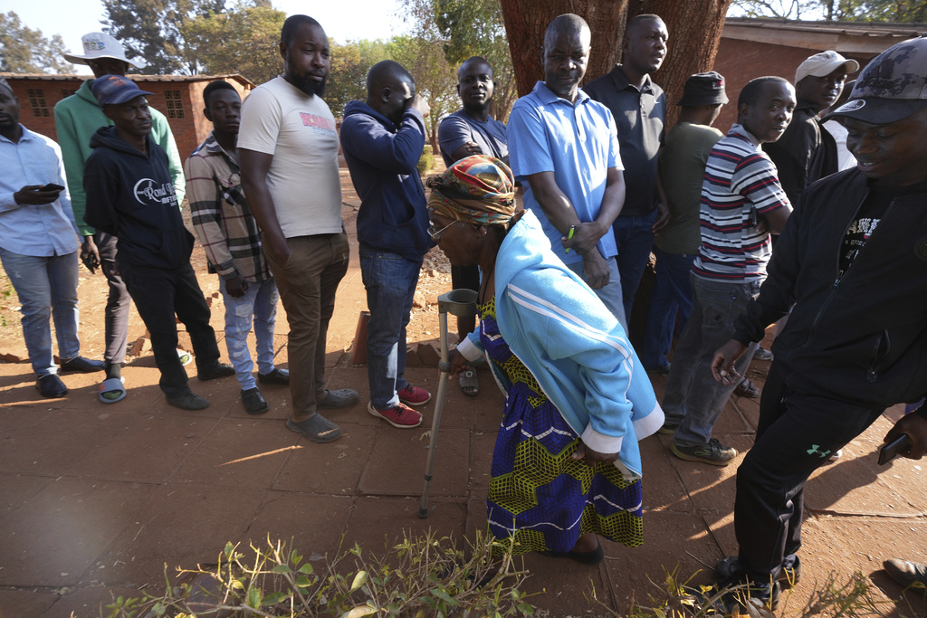 A woman leaves after casting her vote in Harare, Wednesday, Au.g 23 2023. Polls opened in Zimbabwe on Wednesday as President Emmerson Mnangagwa seeks a second and final term in a country with a history of violent and disputed votes. (AP Photo/Tsvangirayi Mukwazhi)