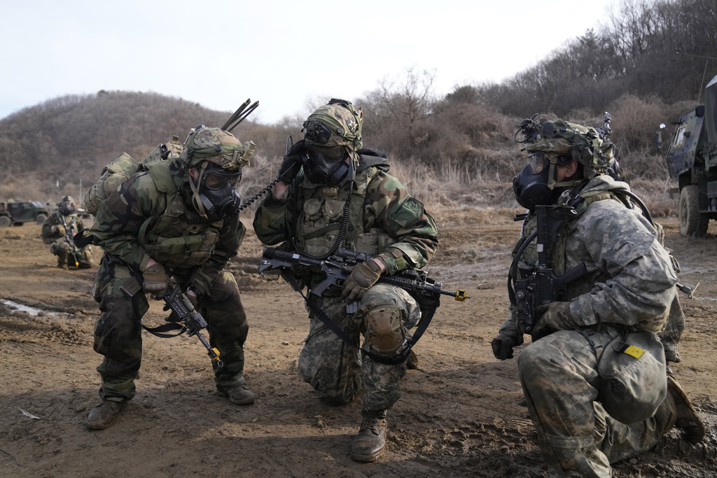 A U.S. soldier, center, talks on a radio during a joint military drill between South Korea and the United States in Paju, South Korea, Thursday, March 16, 2023. North Korea test-launched an intercontinental ballistic missile Thursday just hours before the leaders of South Korea and Japan were to meet at a Tokyo summit expected to be overshadowed by North Korean nuclear threats. The North's first ICBM test in a month and third weapons tests this week also comes as South Korean and U.S. troops continue joint military exercises that Pyongyang considers a rehearsal to invade. (AP Photo/Lee Jin-man)