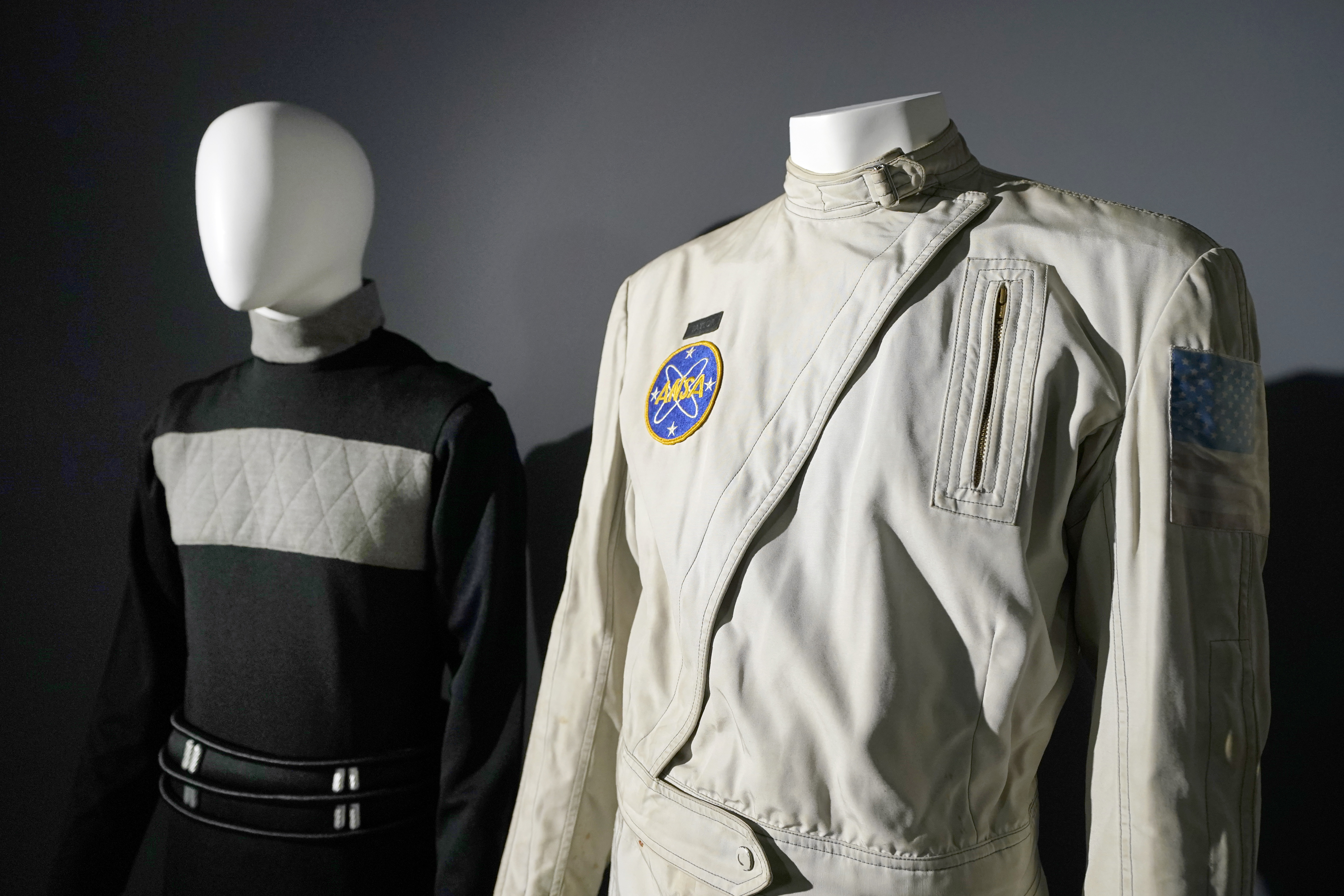 An ANSA flight suit costume prop, right, worn by actor Charlton Heston who played the character 
