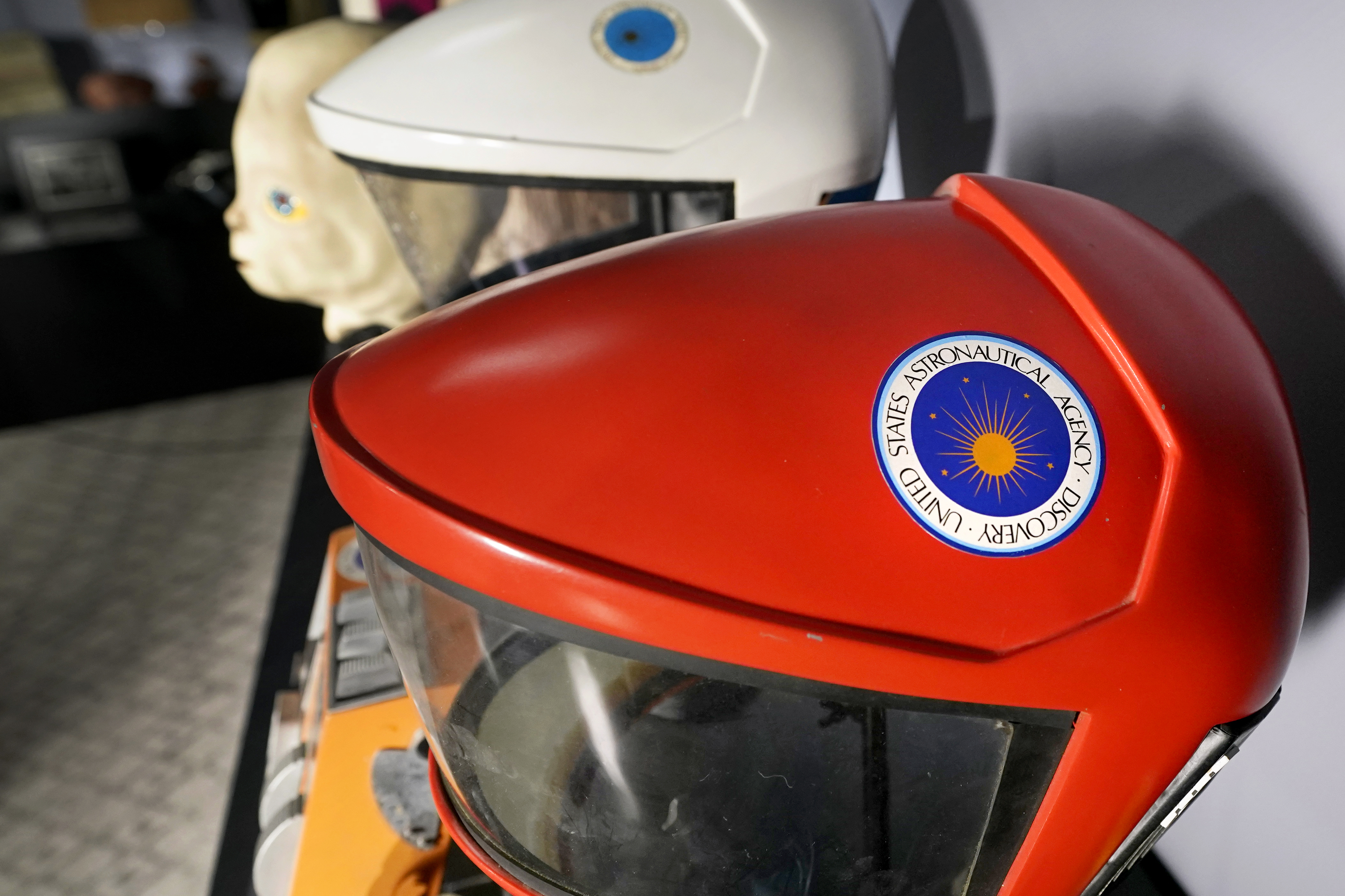 A prop space helmet, front, from the 1984 film, 2010: The Year We Make Contact, sits on display at Heritage Auctions, Thursday, Aug. 30, 2023, in Irving, Texas. While Greg Jein's work over nearly half a century making miniature models in Hollywood included such iconic creations as the alien mothership in 