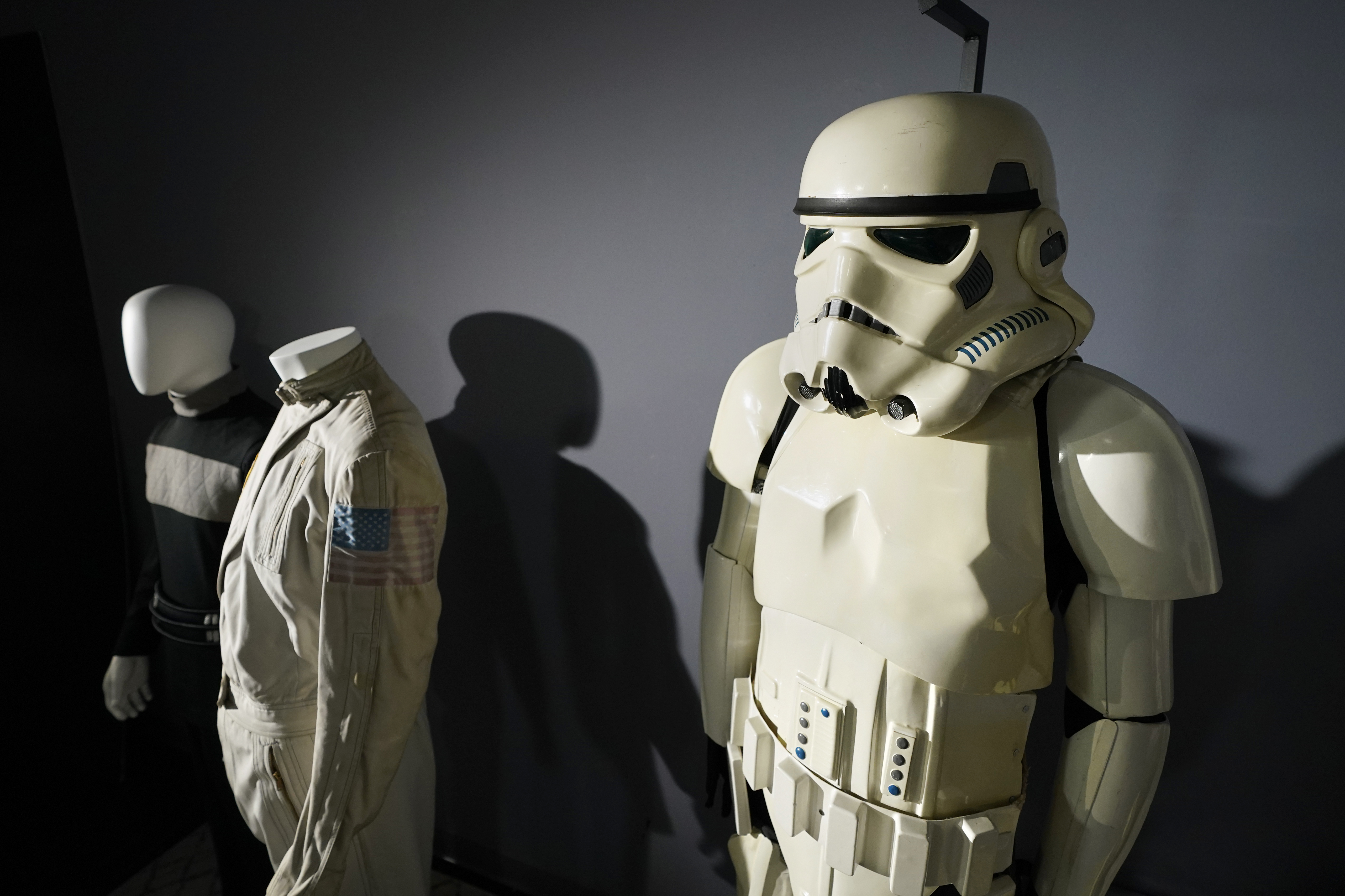 A imperial Stormtrooper costume, right, from the 1977 film, Star Wars, Episode IV, A New Hope, sits on display by other items of the Greg Jein collection at Heritage Auctions, Thursday, Aug. 30, 2023, in Irving, Texas. While Greg Jein's work over nearly half a century making miniature models in Hollywood included such iconic creations as the alien mothership in 