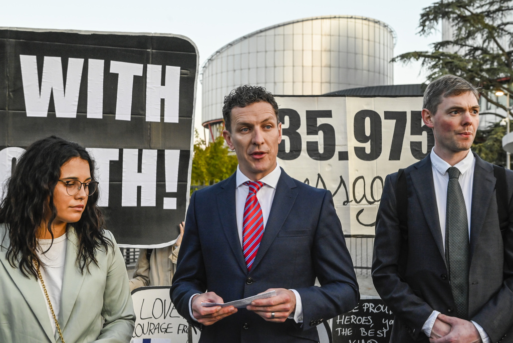 IMAGE DISTRIBUTED FOR AVAAZ -  Director of the Global Legal Action Network Gearoid O Cuinn, centre, and members of the global civic movement Avaaz gather in front of the European Court of Human Rights with messages of support from around the world for the 6 applicants in the 