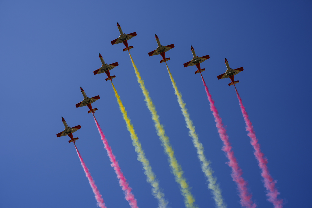 Planes fly over a military parade on Spain's national holiday known as 