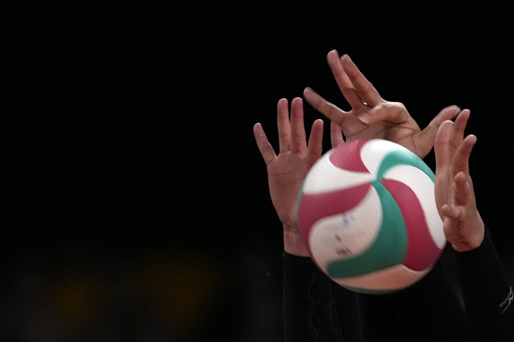 The hands of Mexico's Karen Rivera and teammate Karina Flores block the ball during a women's Volleyball semifinal match against Brazil at the Pan American Games in Santiago, Chile, Wednesday, Oct. 25, 2023. (AP Photo/Moises Castillo)