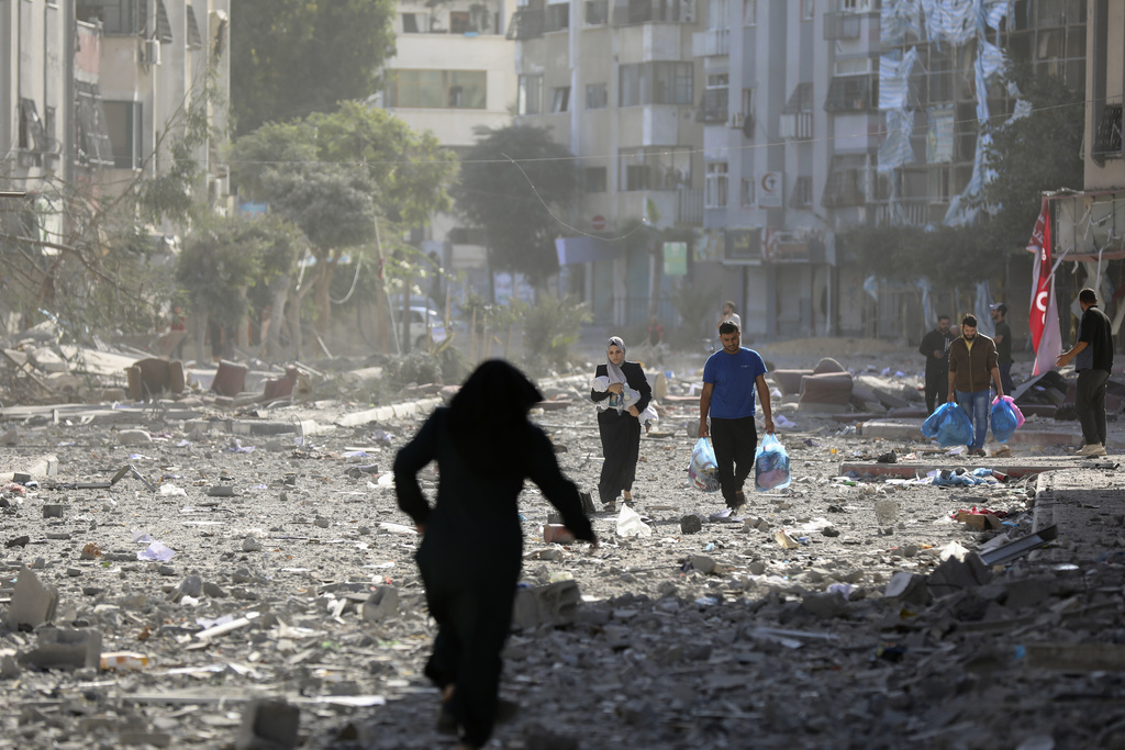 Palestinians leave their homes following Israeli bombardment on Gaza City, Monday, Oct. 30, 2023. (AP Photo/Abed Khaled)