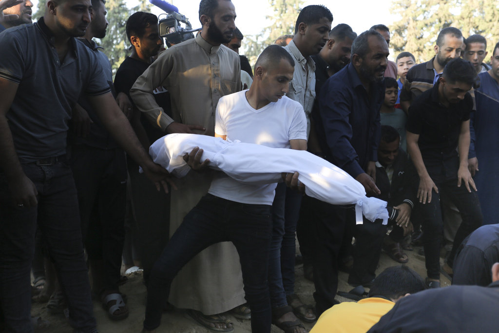 Palestinians bury the members of the Hijazi family who were killed in an Israeli strike in Rafah, Gaza Strip, Tuesday, Oct. 31, 2023. (AP Photo/Hatem Ali)