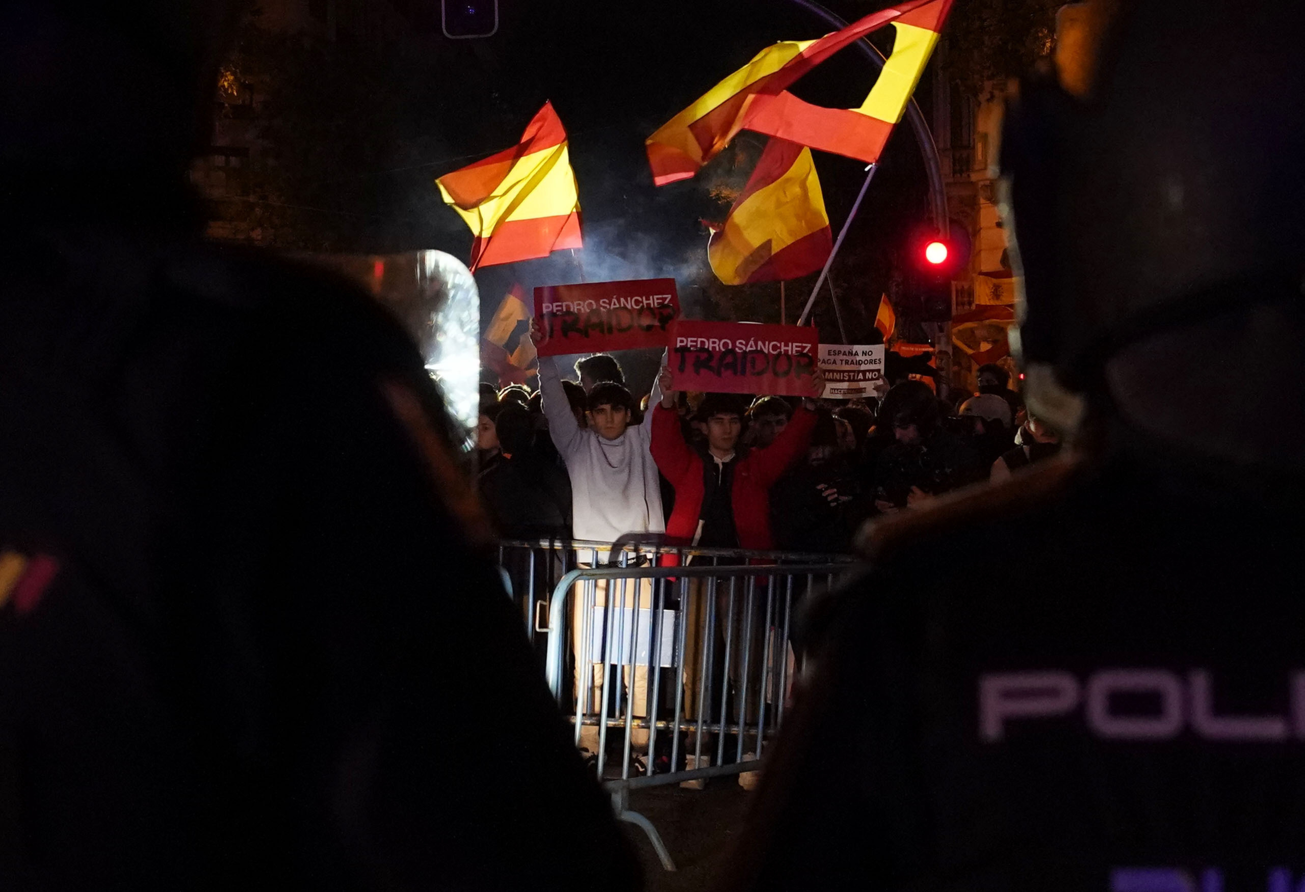 Demonstrators gather to protest against the amnesty at the headquarters of Socialist party in Madrid, Spain, Thursday, Nov. 9, 2023. Protests backed by Vox party turned on Thursday night as Spain's Socialists to grant amnesty to Catalan separatists in exchange for support of new government. (AP Photo/Andrea Comas)