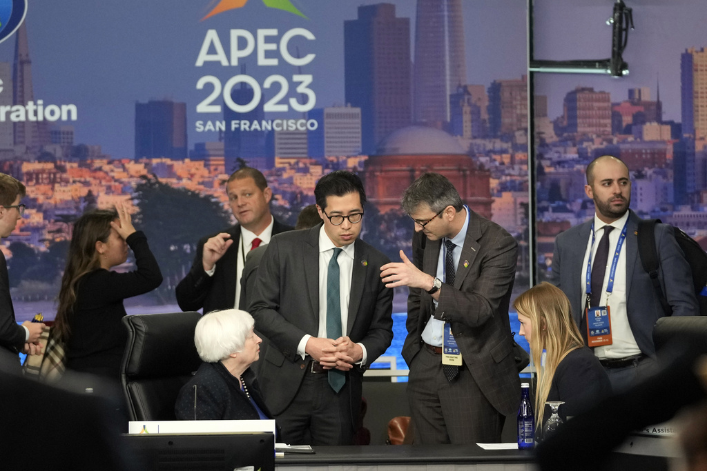 Attendees huddle during a finance ministers meeting, as part of the APEC Summit, Monday, Nov. 13, 2023, in San Francisco. (AP Photo/Eric Risberg)