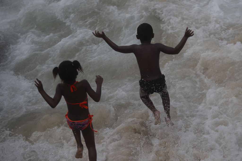 Children cool off in the water at Arpoador beach amid a heat wave in Rio de Janeiro, Brazil, Wednesday, Nov. 15, 2023. (AP Photo/Bruna Prado)