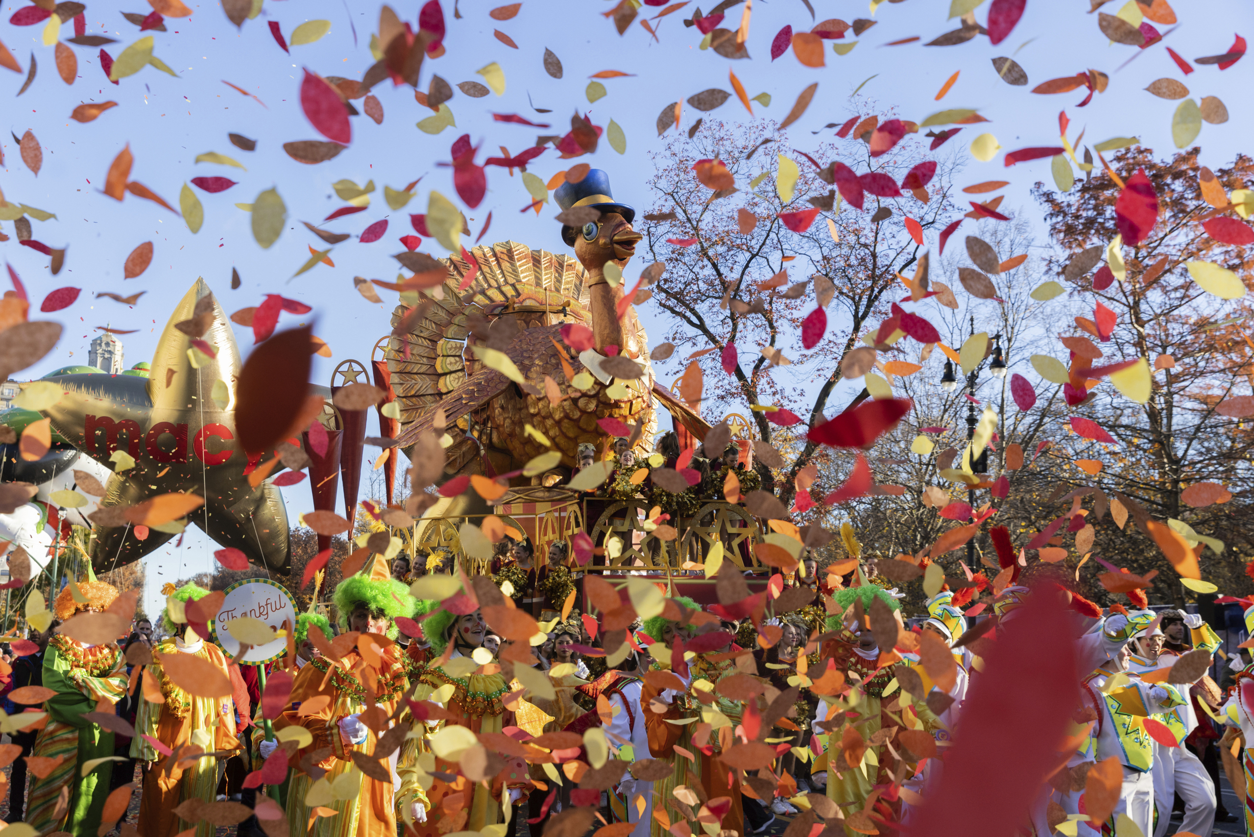 Parade performers lead the Tom Turkey float down Central Park West at the start of the Macy's Thanksgiving Day parade, Thursday, Nov. 23, 2023, in New York. (AP Photo/Jeenah Moon)