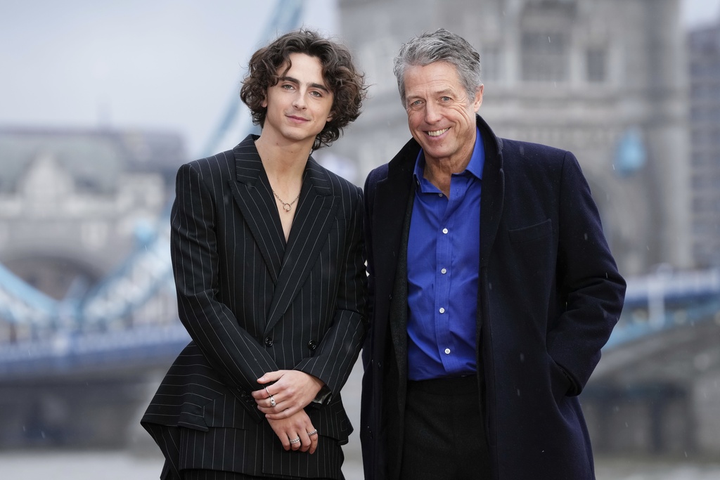 Timothee Chalamet, left, and Hugh Grant pose for photographers upon arrival at the photo call of the film 'Wonka' in London, Monday, Nov. 27, 2023. (Photo by Scott Garfitt/Invision/AP)