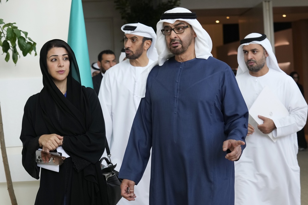 Sheikh Mohammed bin Zayed Al Nahyan, the president of the United Arab Emirates and the ruler of Abu Dhabi, right, walks with Reem al-Hashimy, Emirati minister of state for international cooperation, ahead of the COP28 U.N. Climate Summit, Wednesday, Nov. 29, 2023, in Dubai, United Arab Emirates. (AP Photo/Kamran Jebreili)