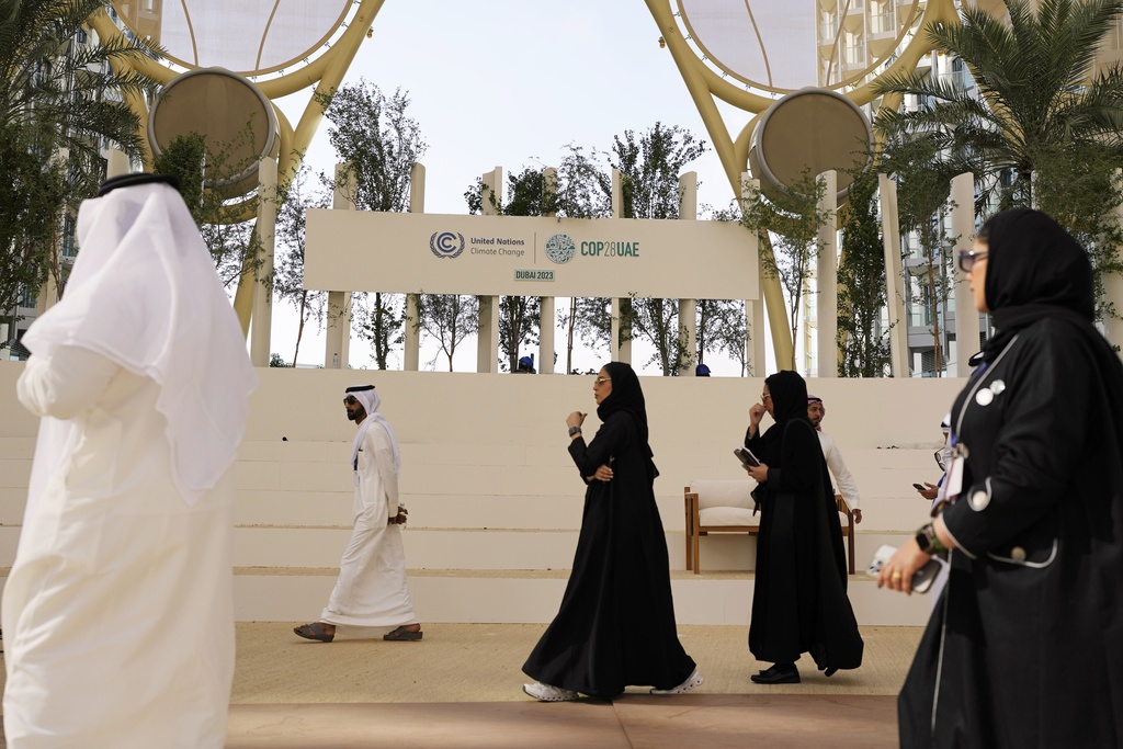 People walk through Al Wasl Dome at Expo City ahead of the COP28 U.N. Climate Summit, Wednesday, Nov. 29, 2023, in Dubai, United Arab Emirates. (AP Photo/Rafiq Maqbool)