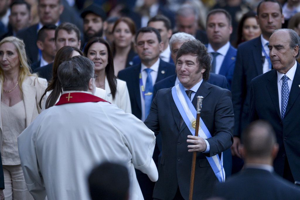 Argentina's newly sworn-in President Javier Milei, center right, arrives at the Metropolitan Cathedral for an interfaith ceremony in Buenos Aires, Argentina, Sunday, Dec. 10, 2023. (AP Photo/Gustavo Garello)