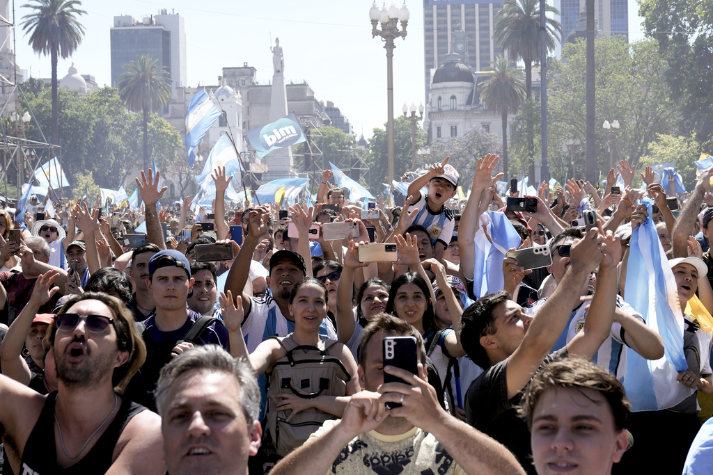 Supporters of Argentina's newly sworn-in President Javier Milei react as he talks from the balcony of the government house in Buenos Aires, Argentina, Sunday, Dec. 10, 2023.(AP Photo/Rodrigo Abd)