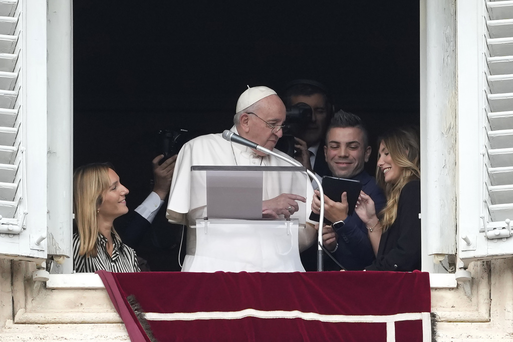 FILE - Pope Francis uses a tablet to sign-up for World Youth Day 2023 at the end of the Angelus noon prayer from the window of his studio overlooking St.Peter's Square, at the Vatican, Sunday, Oct. 23, 2022. Pope Francis called Thursday for an international treaty to ensure artificial intelligence is developed and used ethically, arguing that the risks of technology lacking human values of compassion, mercy, morality and forgiveness are too great. (AP Photo/Alessandra Tarantino, File)