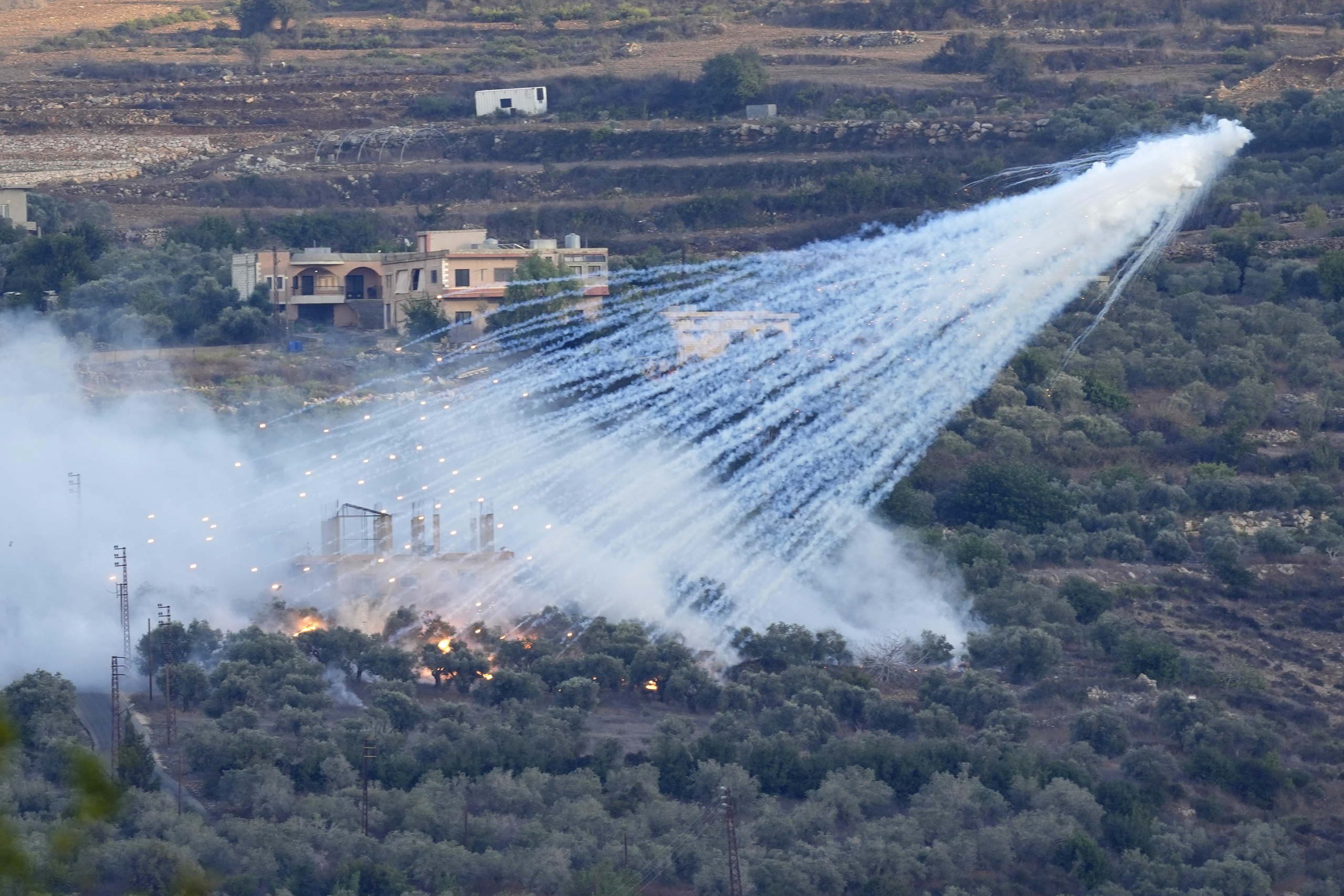 A shell from Israeli artillery explodes over a house in al-Bustan, a Lebanese border village with Israel, south Lebanon, on Oct. 15, 2023. Hamas Palestinian militants in southern Lebanon fired 20 rockets into the northern Israeli towns of Schlomi and Nahariyya, the group said in a statement. They said it was 