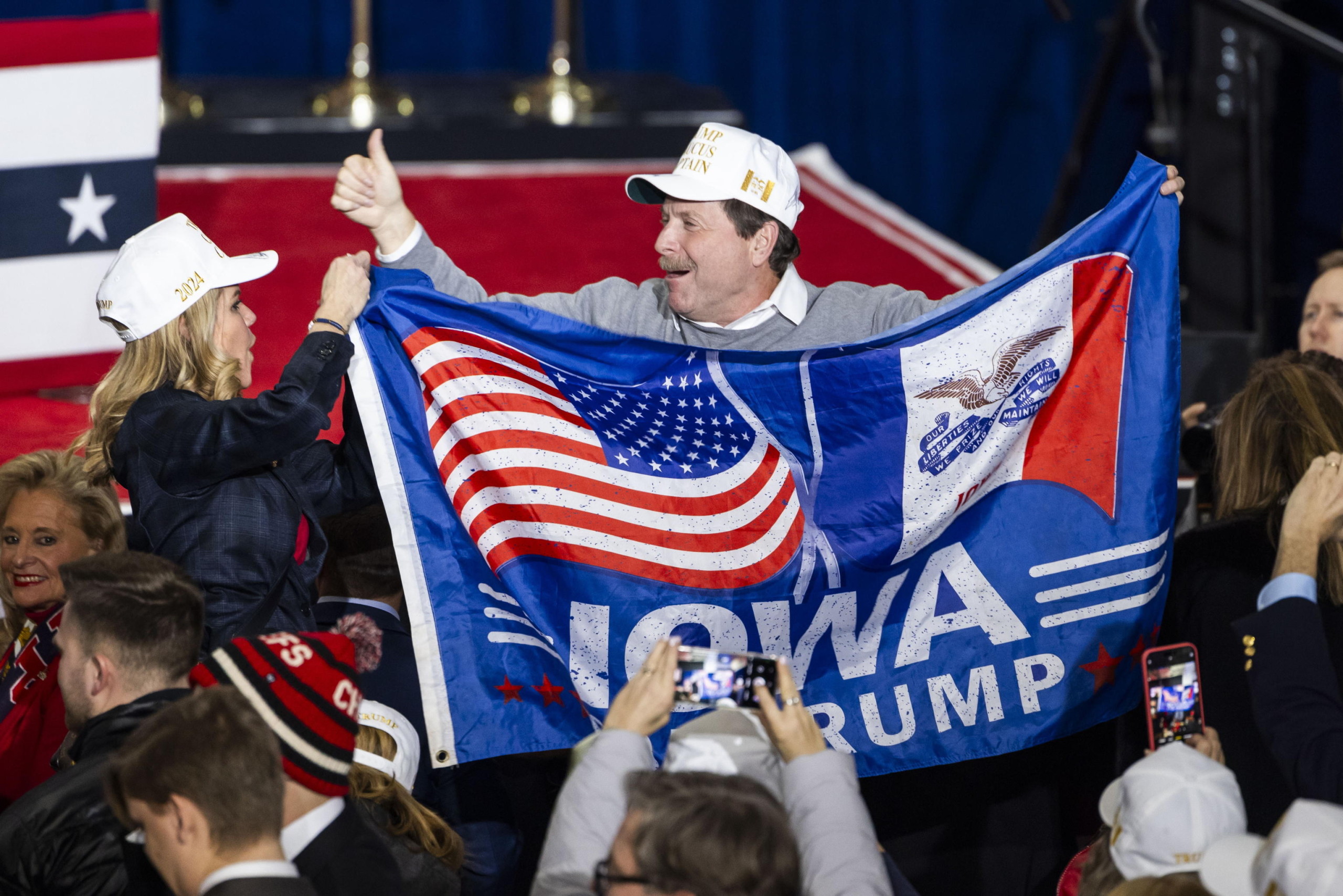 epa11081149 Supporters of former President Donald Trump wait for him to speak at the Iowa Events Center after Trump won the first-in-the-nation Iowa caucus in Des Moines, Iowa, USA, 15 January 2024. Trump won the state handily, defeating former South Carolina Governor Nikki Haley and Florida Governor Ron DeSantis. The Republican presidential race now moves to New Hampshire for that state's Republican primary on 23 January.  EPA/JIM LO SCALZO