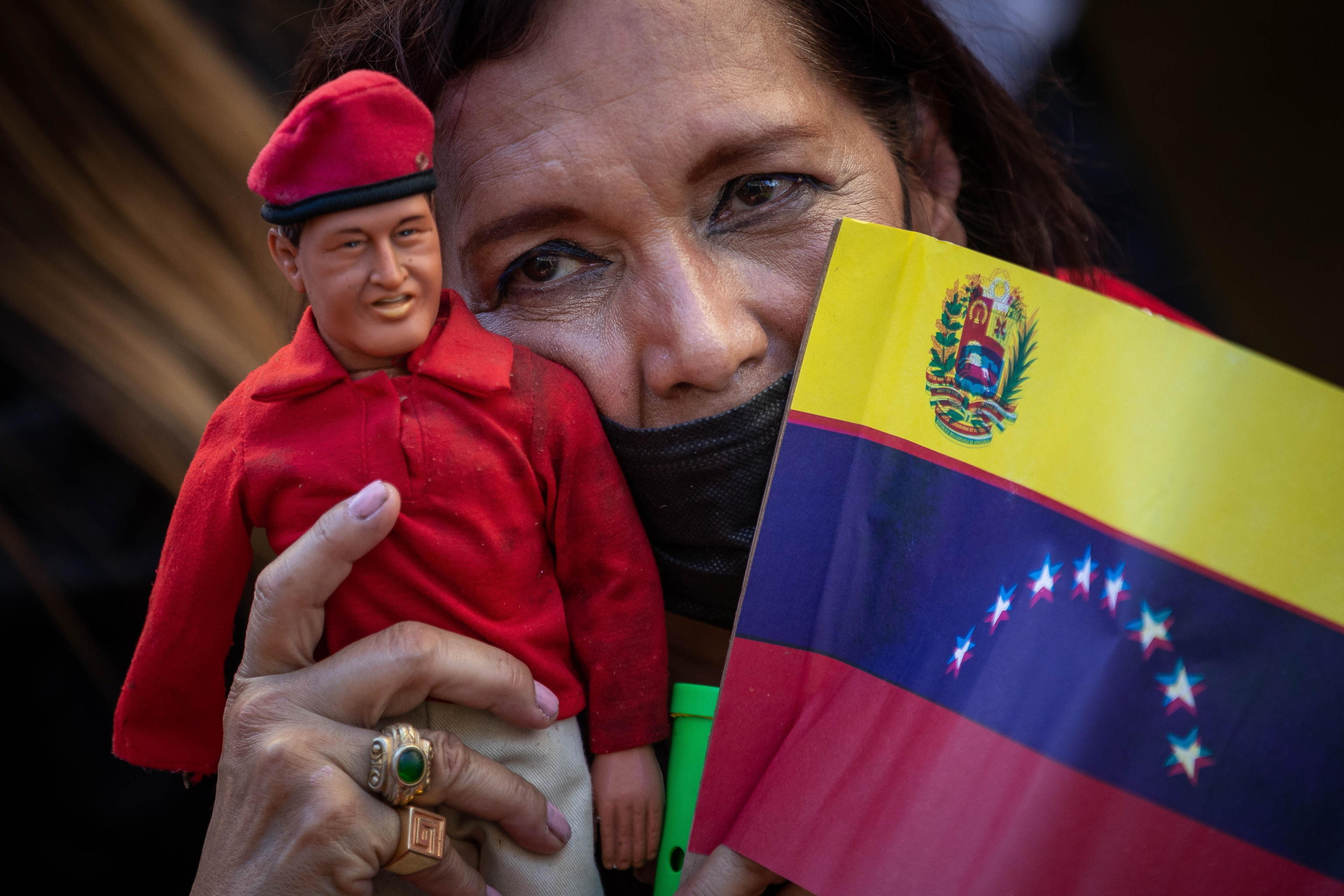 epa11099829 A woman carries a doll of late former president Hugo Chavez during a march in support of the government of Nicolas Maduro in Caracas, Venezuela, 23 January 2024. Maduro assured that he will continue to govern the country 