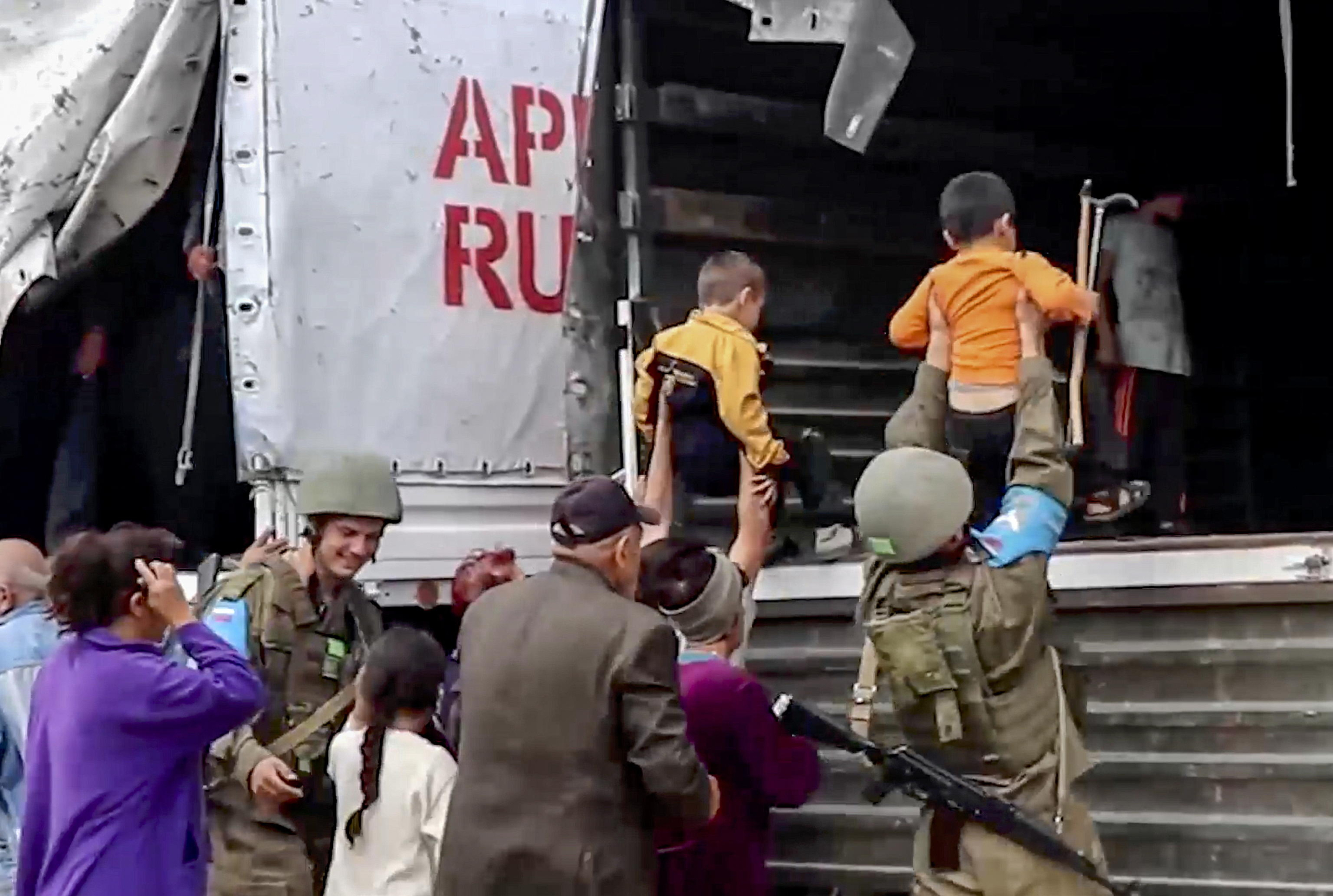 epa10882544 A still image taken from a handout video provided by the Russian Defence Ministry press-service shows Russian peacekeepers evacuating Nagorno-Karabakh civilians at an undisclosed location, 25 September 2023. Over the past 24 hours, Russian military personnel ensured the delivery of 190 tons of cargo with food and fuel and other aid for the civilian population of Karabakh, the Russian Ministry of Defence said on 25 September. Russian peacekeepers escorted the transport of civilians from the Martuni region, delivering 70 people to Stepanakert, the ministry added. Some 715 civilians, including 402 children, have been taken to the Russian peacekeeping contingent, where they have been provided with accommodation, food and medical assistance. Azerbaijan on 19 September 2023 launched a brief military offensive on the contested region of Nagorno-Karabakh, a breakaway enclave that is home to some 120,000 ethnic Armenians. The Armenian government announced the evacuation of about 3,000 local residents from the region following the ceasefire agreed on 20 September 2023, as Azerbaijan opened all checkpoints with Armenia for the unimpeded exit of civilians from the territory of Nagorno-Karabakh. Russian peacekeepers escorted convoys of civilians from Nagorno-Karabakh leaving for Armenia, the Russian Ministry of Defense reported.  EPA/RUSSIAN DEFENCE MINISTRY PRESS SERVICE HANDOUT -- MANDATORY CREDIT -- BEST QUALITY AVAILABLE -- HANDOUT EDITORIAL USE ONLY/NO SALES