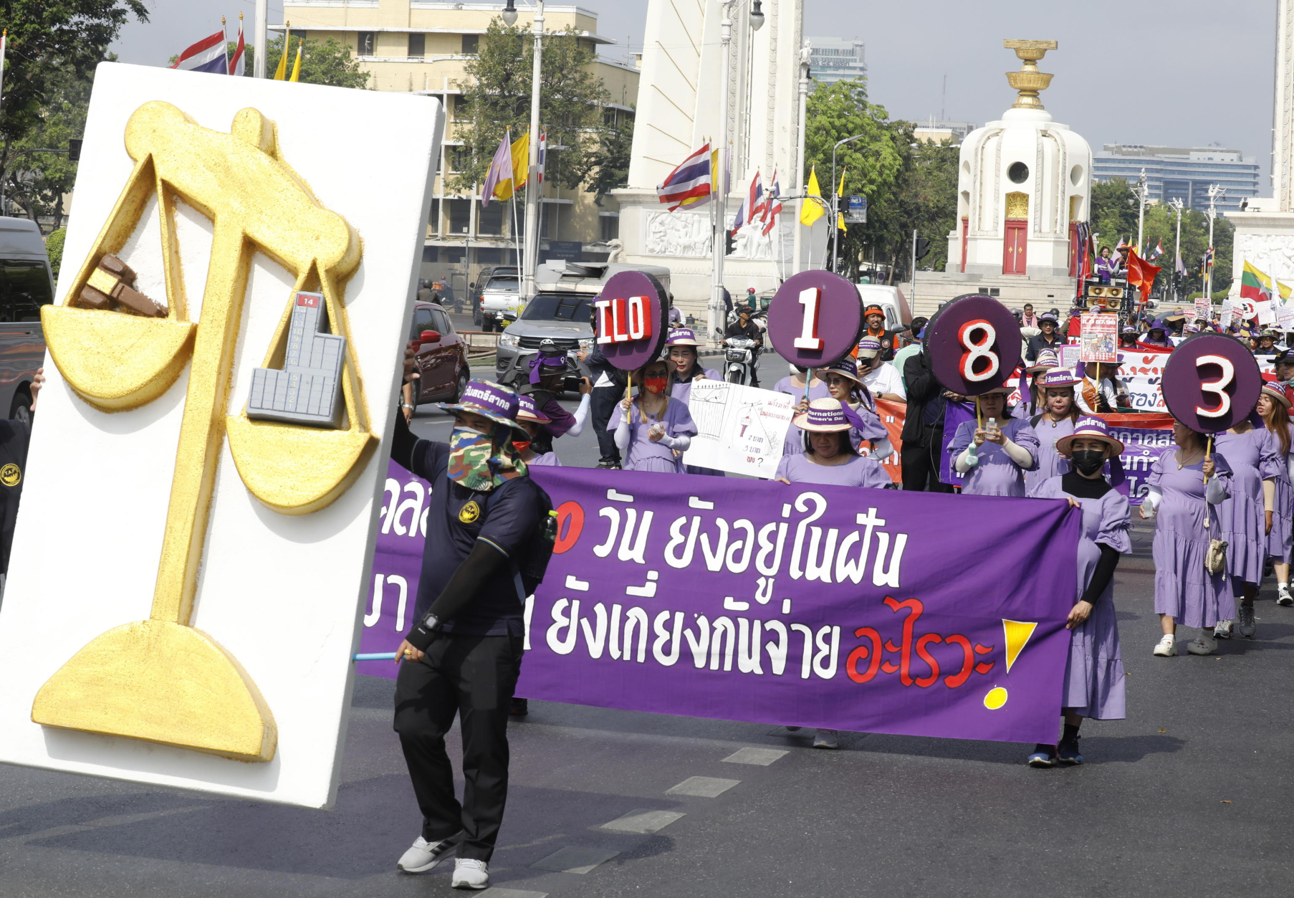 epa11206010 Female workers dressed up as pregnant women hold banners as they attend a demonstration to mark International Women's Day on a road in Bangkok, Thailand, 08 March 2024. Hundreds of female workers and their supporters rallied and marched to the Government House to call for better employment conditions and a good quality of life, equal rights for female labor, including the protection of maternity rights that include 180 days of maternity leave and subsidies for young children too. The demonstration was held in the scope of the commemorations of International Women's Day, which is observed every year on 08 March.  EPA/NARONG SANGNAK