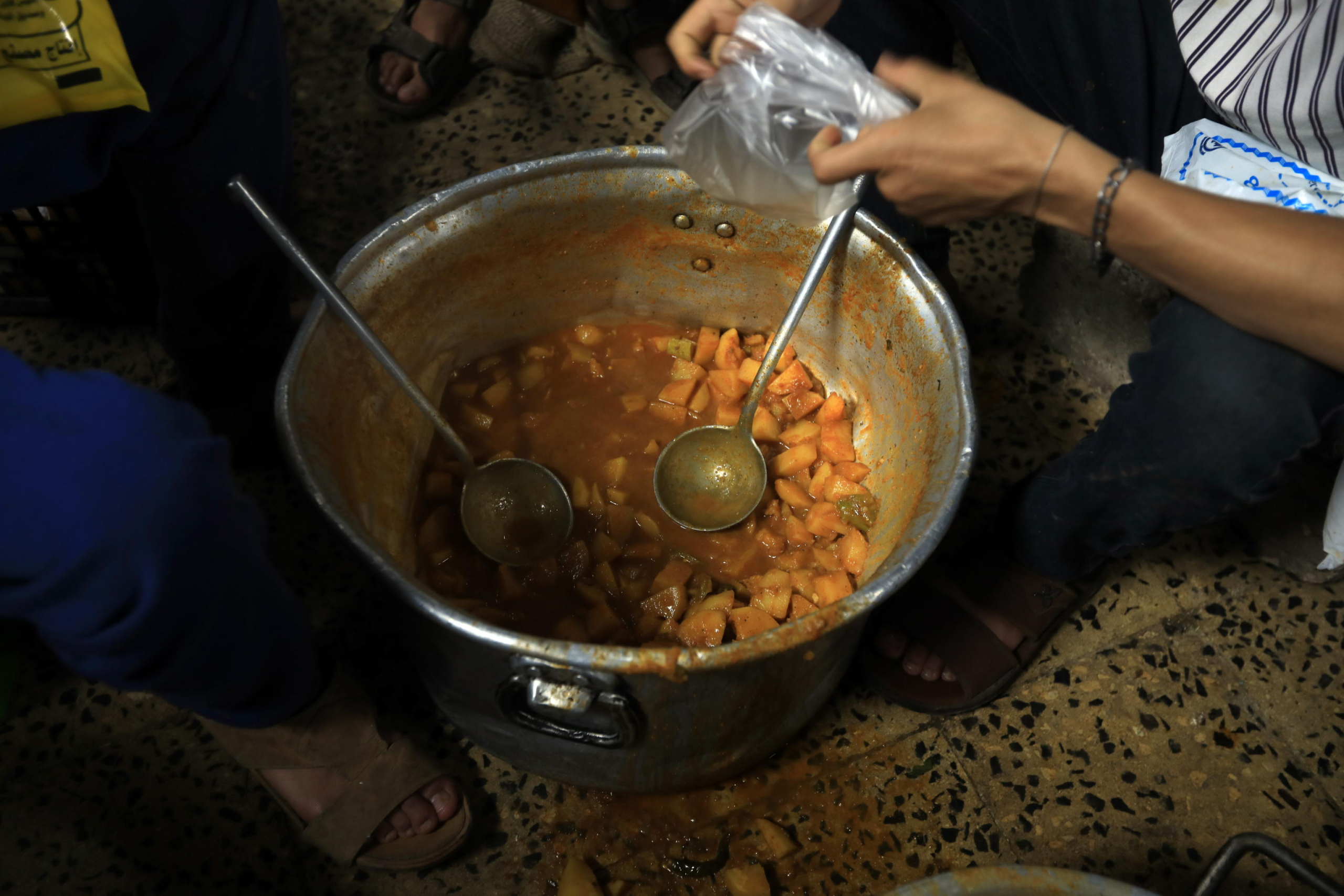 epa11248881 Volunteers prepare food aid for iftar, a meal traditionally taken after sunset to break the Ramadan daily fast during the fasting month of Ramadan, at a charitable kitchen in Sana'a, Yemen, 28 March 2024. More than 2,000 families in the Sana'a neighborhood receive daily food aid, including rice, cooked vegetables, and bread, provided by a charitable kitchen during the fasting month of Ramadan. The Muslims' holy month of Ramadan is the ninth month in the Islamic calendar, and it is believed that the revelation of the first verse in the Koran took place during the last ten nights. It is celebrated yearly by praying during the night time and abstaining from eating, drinking, and sexual acts during the period between sunrise and sunset. It is also a time for socializing, mainly in the evening after breaking the fast and a shift of all activities to late in the day in most countries.  EPA/YAHYA ARHAB