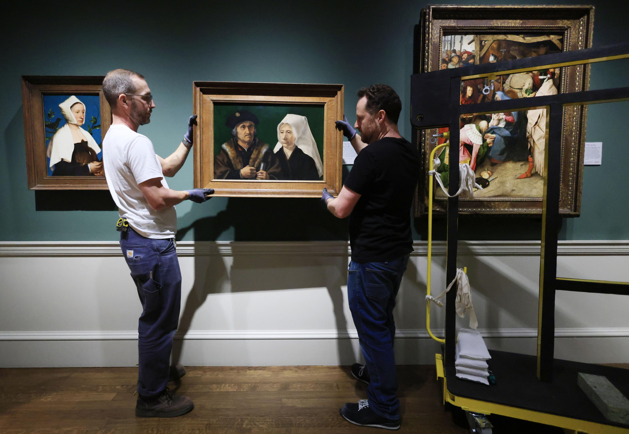 epa11328623 Art handers hang the work 'An Elderly Couple' by Dutch artist Jan Gossaert in the National Gallery in London, Britain, 09 May 2024. On 10 May 2024 the National Gallery celebrates its Bicentenary. The National Gallery was established in 1824 with the first 38 paintings donated by banker John Julius Angerstein. The collection was initially displayed in a townhouse at 100 Pall Mall. After this became too small,  a new building was completed on Trafalgar Square in 1838 designed by the architect William Wilkins. The art collection currently comprises 2,300 works, spanning the major traditions of Western European painting with works by Van Gogh, Caravaggio, Turner, Constable, Michelangelo, Velazquez and Rembrandt. The National Gallery building welcomed over three million visitors in 2023,  which is open 361 days a year, free of charge. The National Gallery will mark the bicentenary year with 12 months of events celebrating art and creativity across the UK.  EPA/NEIL HALL  ATTENTION: This Image is part of a PHOTO SET