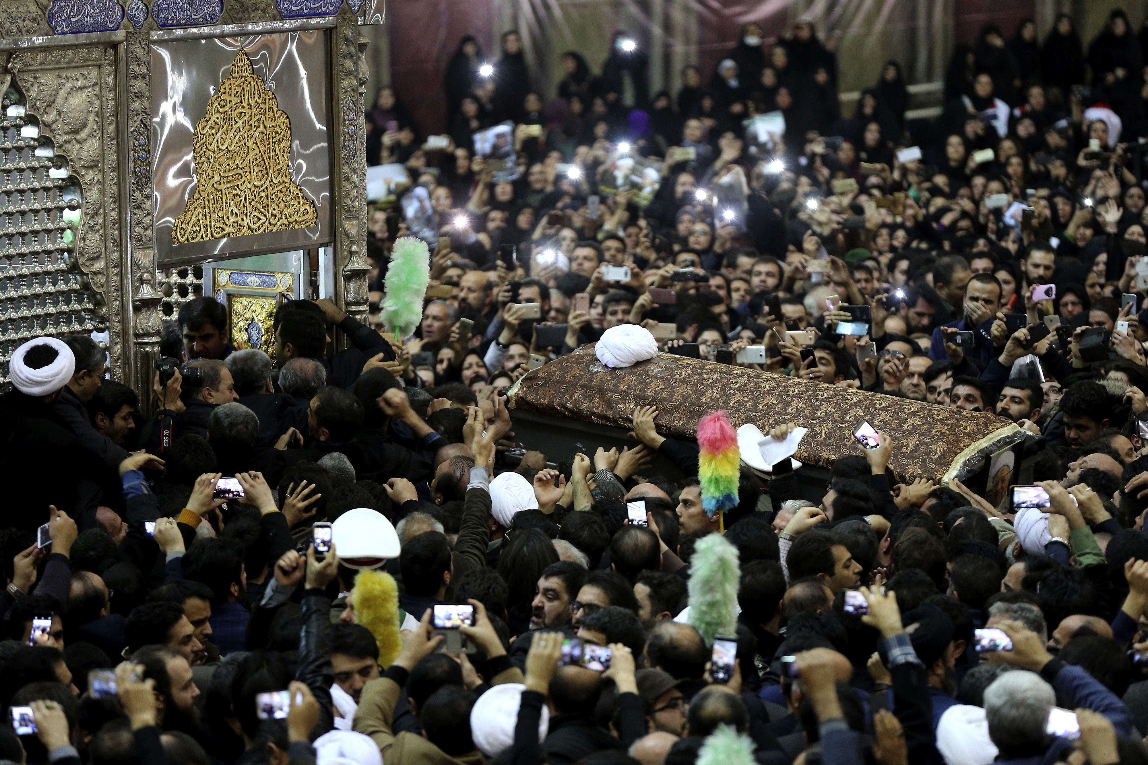 Mourners carry the coffin of former Iranian President Akbar Hashemi Rafsanjani during his burial at the shrine of the late revolutionary founder Ayatollah Khomeini just outside Tehran, Iran, Tuesday, Jan. 10, 2017. Hundreds of thousands mourned the late Iranian President Akbar Hashemi Rafsanjani on Tuesday, wailing in grief as his body was interred at a Tehran shrine alongside the leader of the country's 1979 Islamic Revolution. Rafsanjani's final resting place near the late Supreme Leader, Ayatollah Ruhollah Khomeini, reflected his legacy as one of the pillars of Iran's clerical-dominated political system, as he served in later years as a go-between for hard-liners and reformists. (AP Photo/Ebrahim Noroozi)