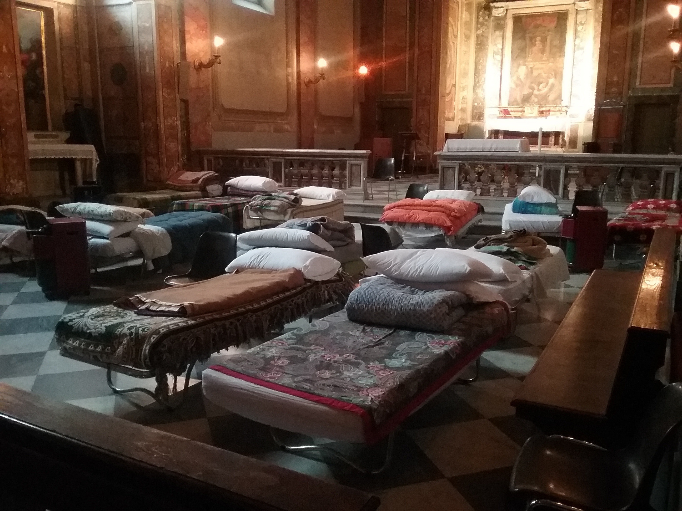 In this undated photo beds are lined up inside the St. Calixtus church in Rome, The Vatican is letting homeless people sleep in a Rome church during a spell of unusually cold weather for the Italian capital. In Rome lately, nighttime temperatures have dropped below freezing. The Vatican say that around 30 people, Italians and foreigners, have accepted the invitation to sleep inside St. Calixtus church, whose foundations were laid near a well where Pope Calixtus I was martyred in 222. (L'Osservatore Romano/Pool Photo via AP)