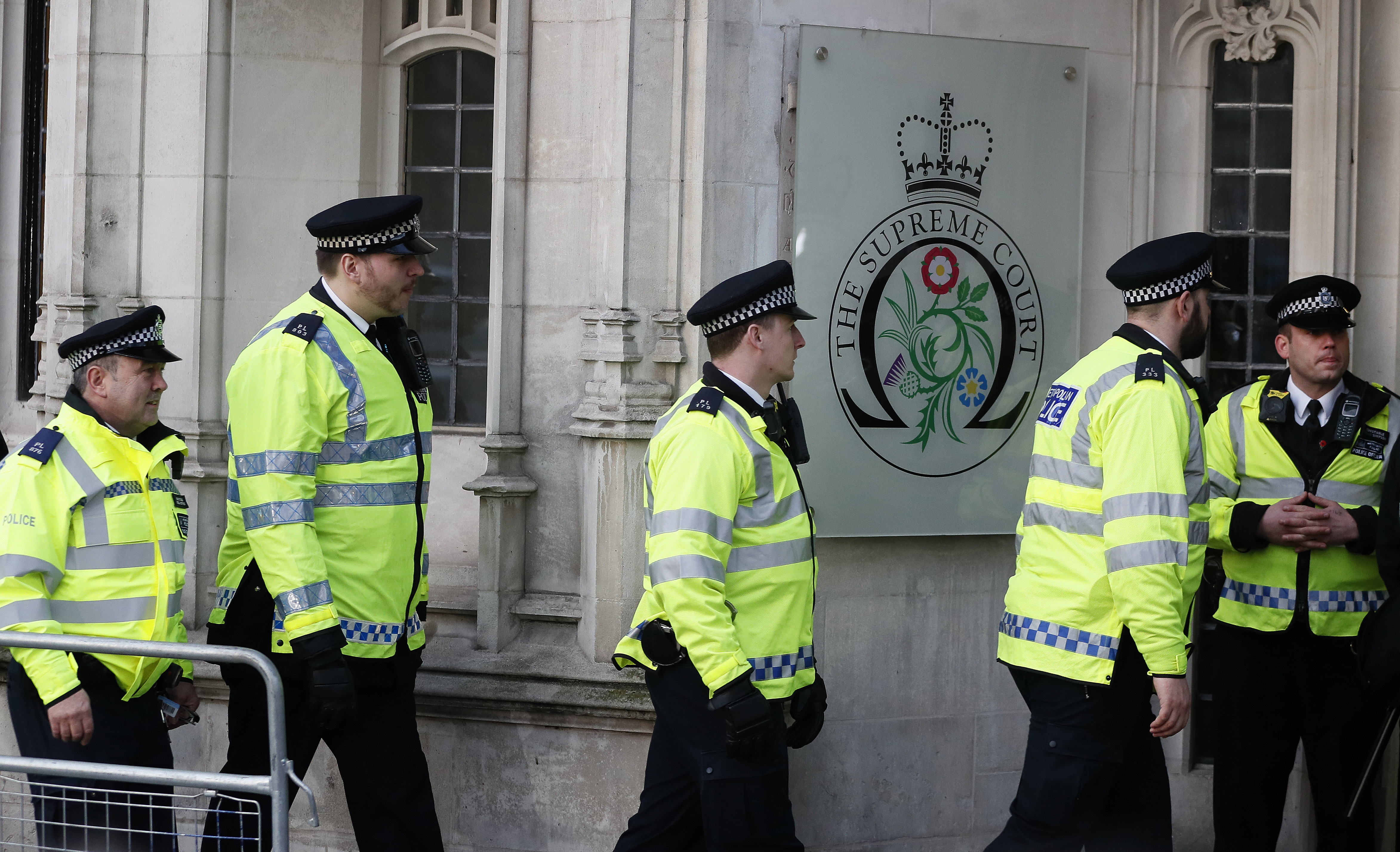 Police officers arrive at the Supreme Court in London, Tuesday, Jan. 24, 2017. Britain's Supreme Court will rule Tuesday on whether the prime minister or Parliament has the right to trigger the process of taking Britain out of the European Union. (AP Photo/Kirsty Wigglesworth)