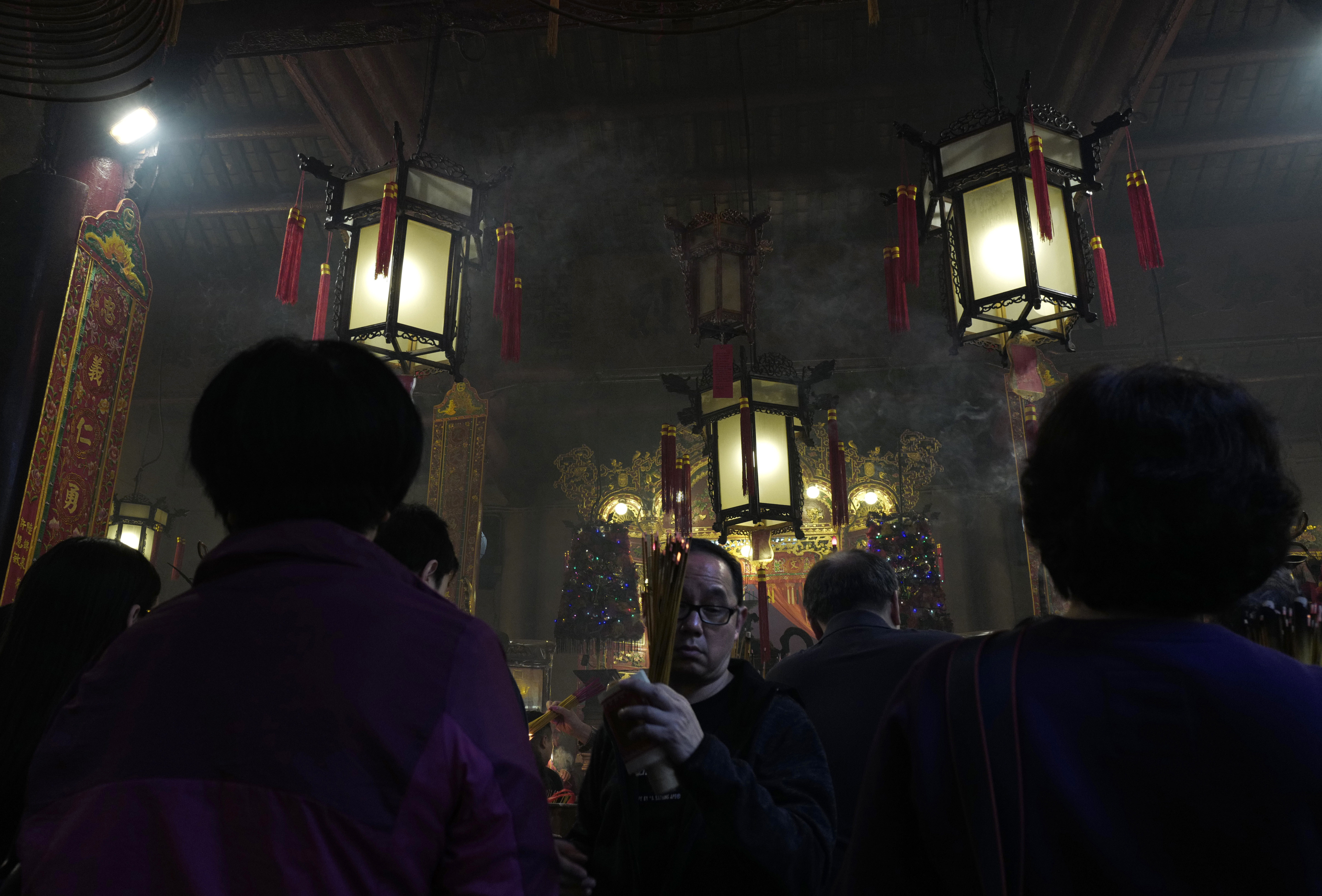 People burn joss sticks as they pray at the Man Mo Miu Temple on the third day of the Lunar New Year in Hong Kong, Monday, Jan. 30, 2017. Chinese are celebrating the Lunar New Year, which marks the Year of the Rooster on the Chinese zodiac. (AP Photo/Vincent Yu)