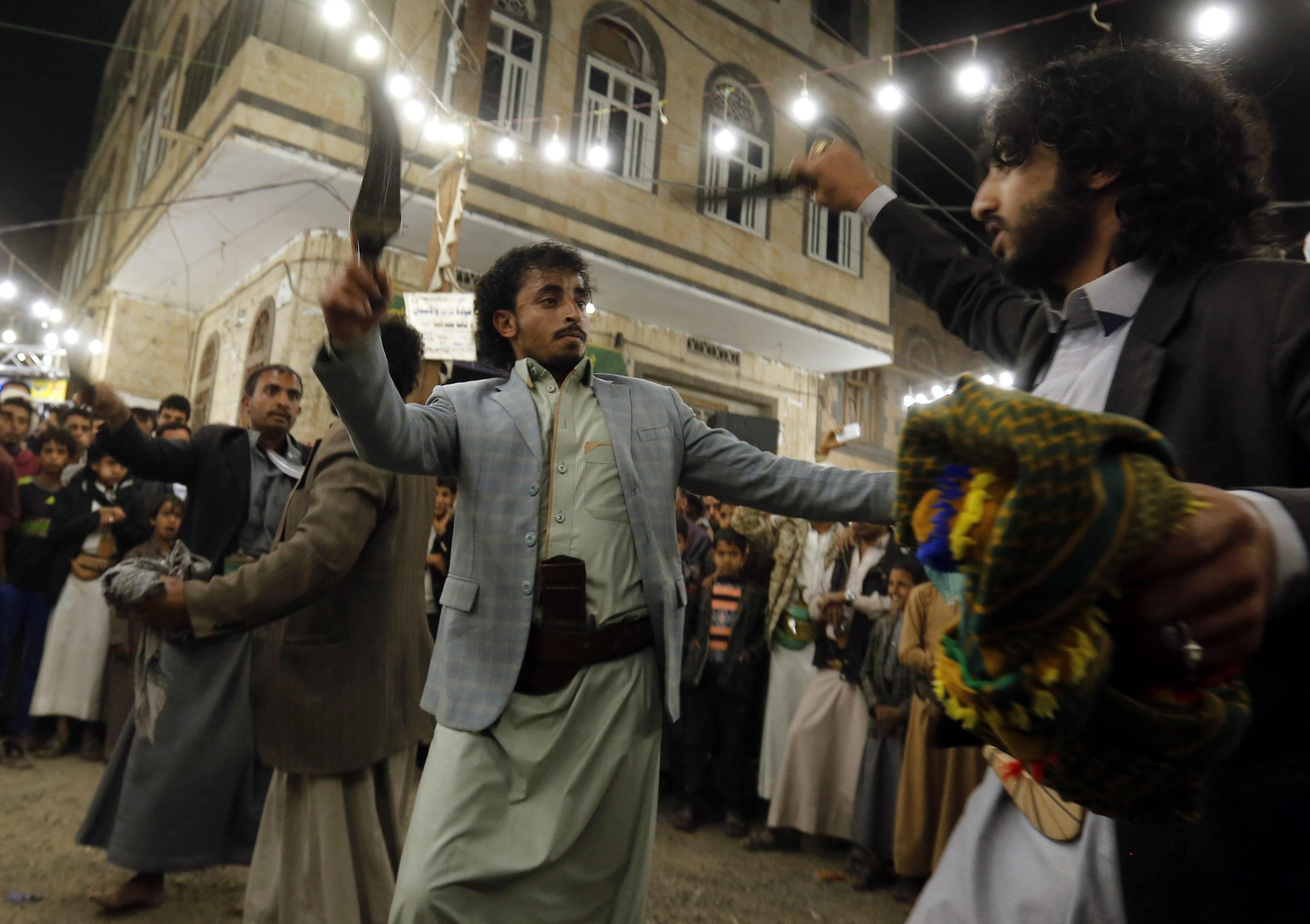 epaselect epa05775345 A picture made available on 06 February 2017 shows Yemenis performing traditional dances during a wedding ceremony in Sana'a, Yemen, 05 February 2017. Yemen has unique traditions that gives a special character to its weddings, which are costly and lavish, especially considering the country's low per capita income and its 22-month ongoing conflict. Upon strict Muslim traditions practiced in Yemen, the wedding parties are held without intermixing; the brides and grooms are kept in separate halls.  EPA/YAHYA ARHAB
