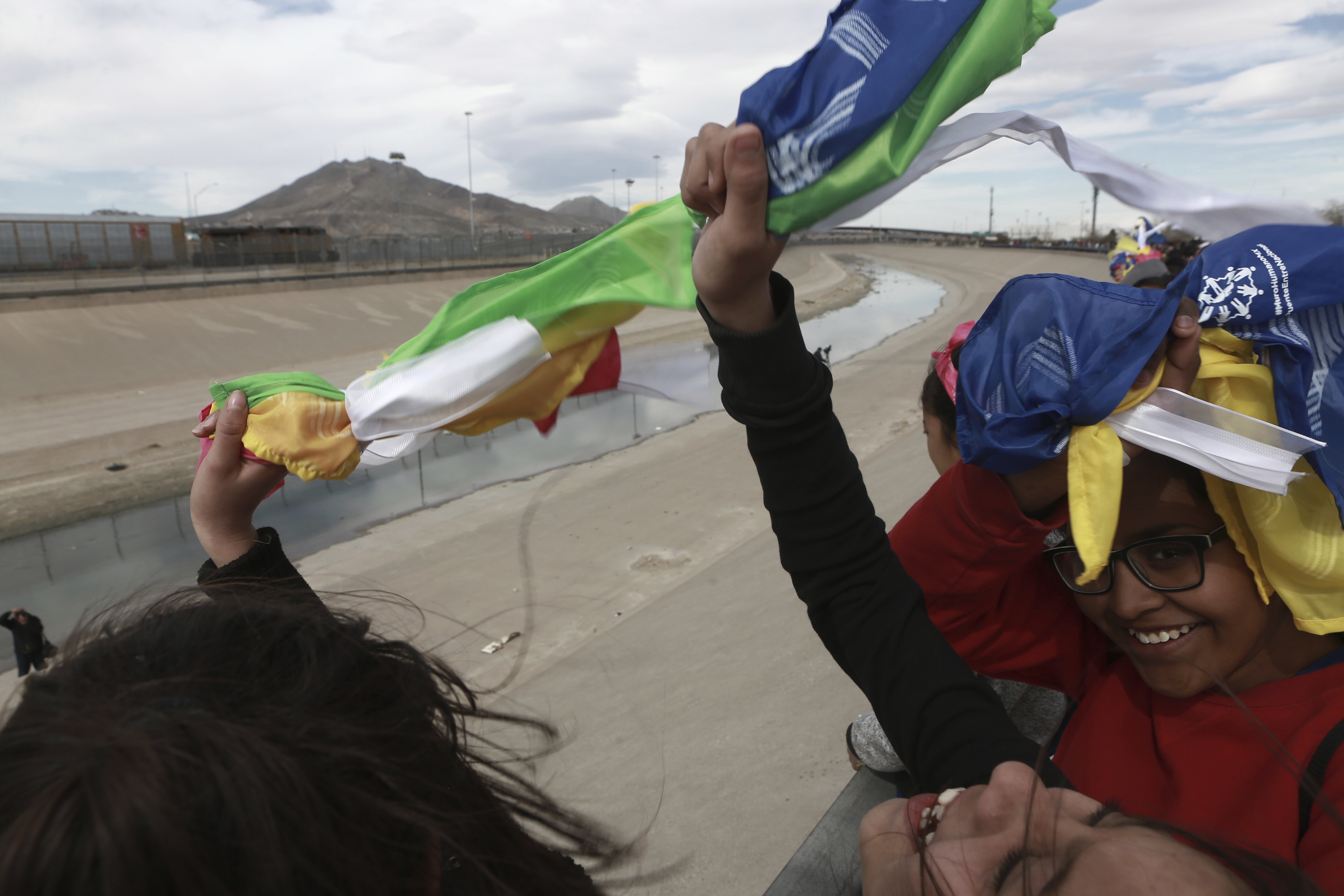People wave colored flags reading 