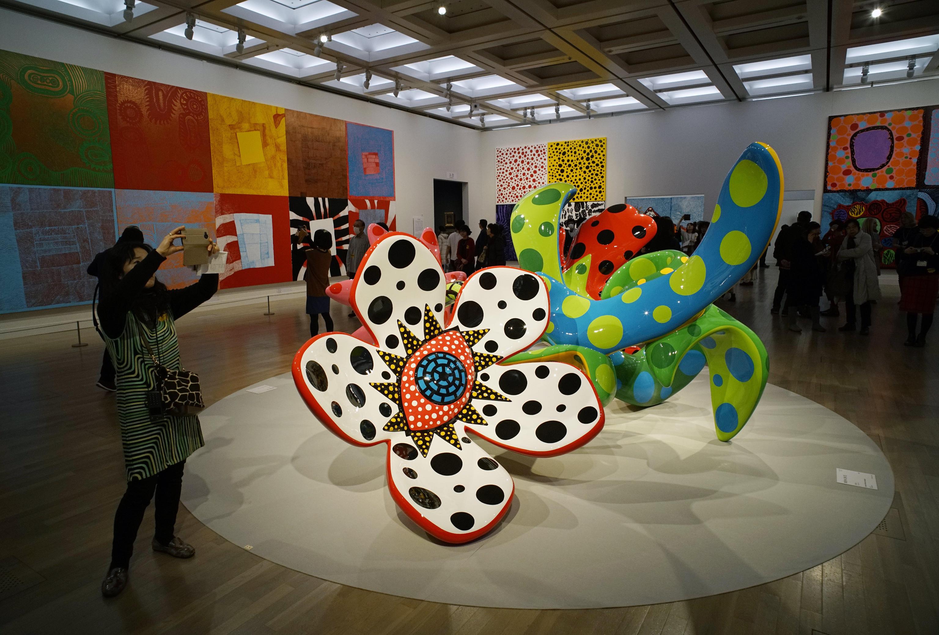 epa05806268 Visitors look at sculptures from the series 'Flowers that Bloom at Midnight' and 'Flowers that Bloom Tomorrow' by Japanese artist Yayoi Kusama during a media preview of the 'Yayoi Kusama: My Eternal Soul' exhibition at the National Art Center in Tokyo, Japan, 21 February 2017. The exhibition presents early and recent works by the 87-year-old artist and will be open to the public from 22 February to 22 May 2017.  EPA/FRANCK ROBICHON   EDITORIAL USE ONLY