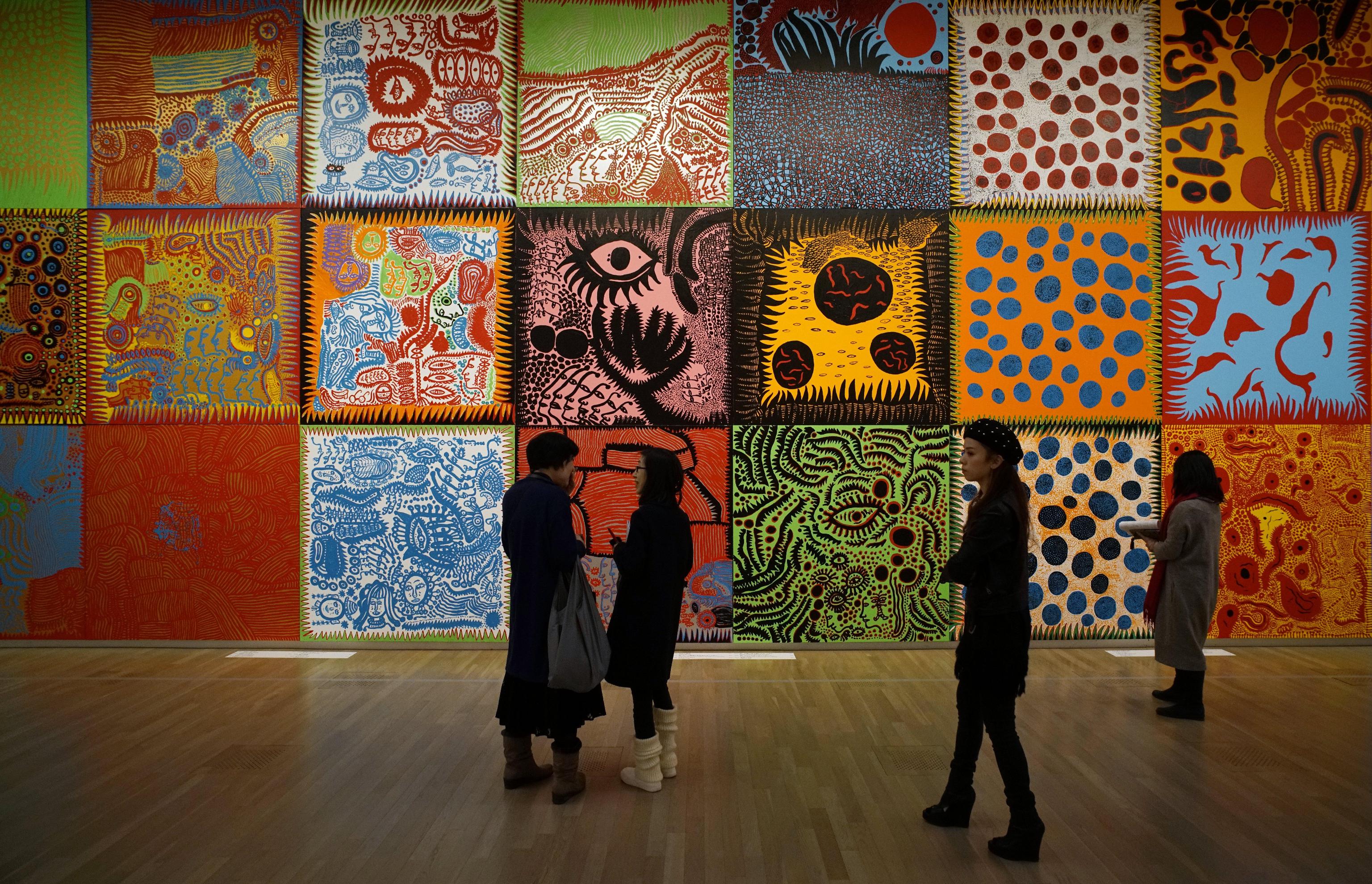 epa05806265 Visitors look at works by Japanese artist Yayoi Kusama during a media preview of the 'Yayoi Kusama: My Eternal Soul' exhibition at the National Art Center in Tokyo, Japan, 21 February 2017. The exhibition presents early and recent works by the 87-year-old artist and will be open to the public from 22 February to 22 May 2017.  EPA/FRANCK ROBICHON   EDITORIAL USE ONLY