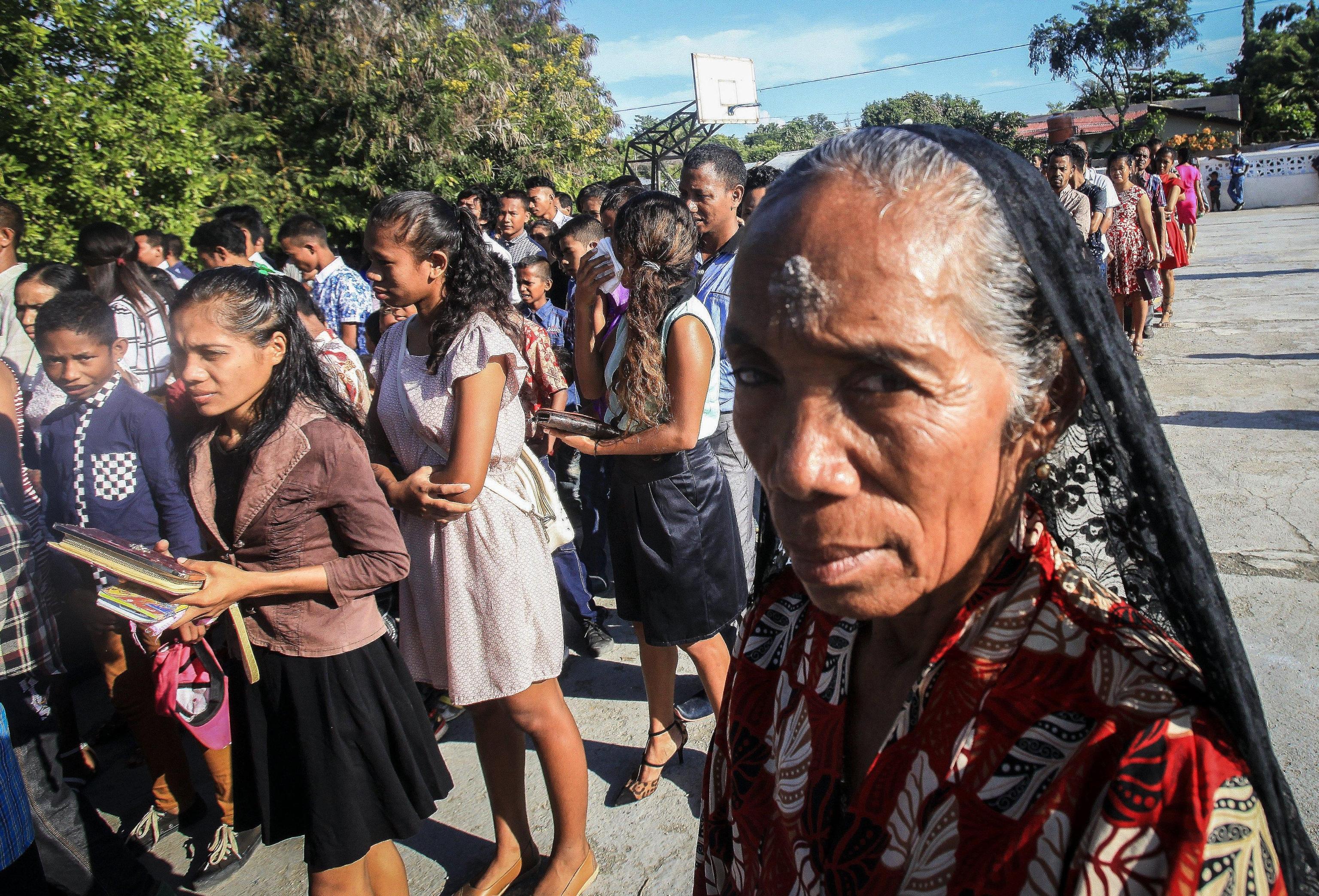 epa05822169 East Timorese Catholic worshippers line up to receive black soot marks on their foreheads as they observe Ash Wednesday at the Komoro Catholic church in Dili, East Timor, also known as Timor Leste, 01 March 2017. Ash Wednesday marks the beginning of the 40-day season of Lent in the Roman Catholic religion.  EPA/ANTONIO DASIPARU