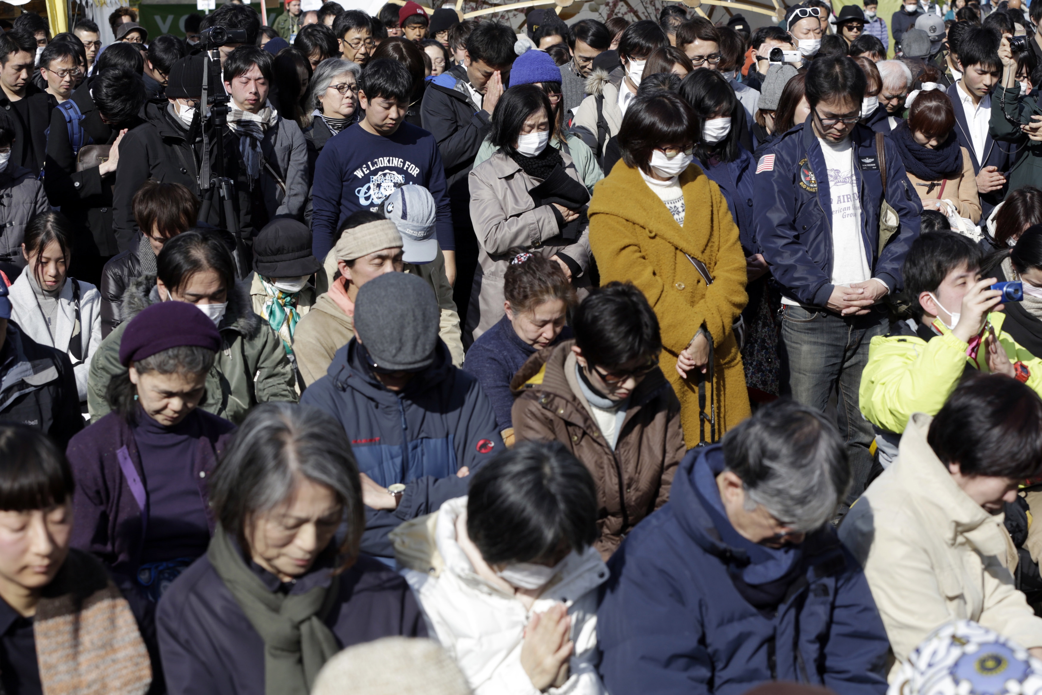 People mourn the victims of the March 11, 2011 earthquake and tsunami during a special memorial event in Tokyo, Saturday, March 11, 2017. Japan on Saturday marked the sixth anniversary of the 2011 tsunami that killed more than 18,000 people and left a devastated coastline along the country's northeast that has still not been fully rebuilt. (AP Photo/Eugene Hoshiko)