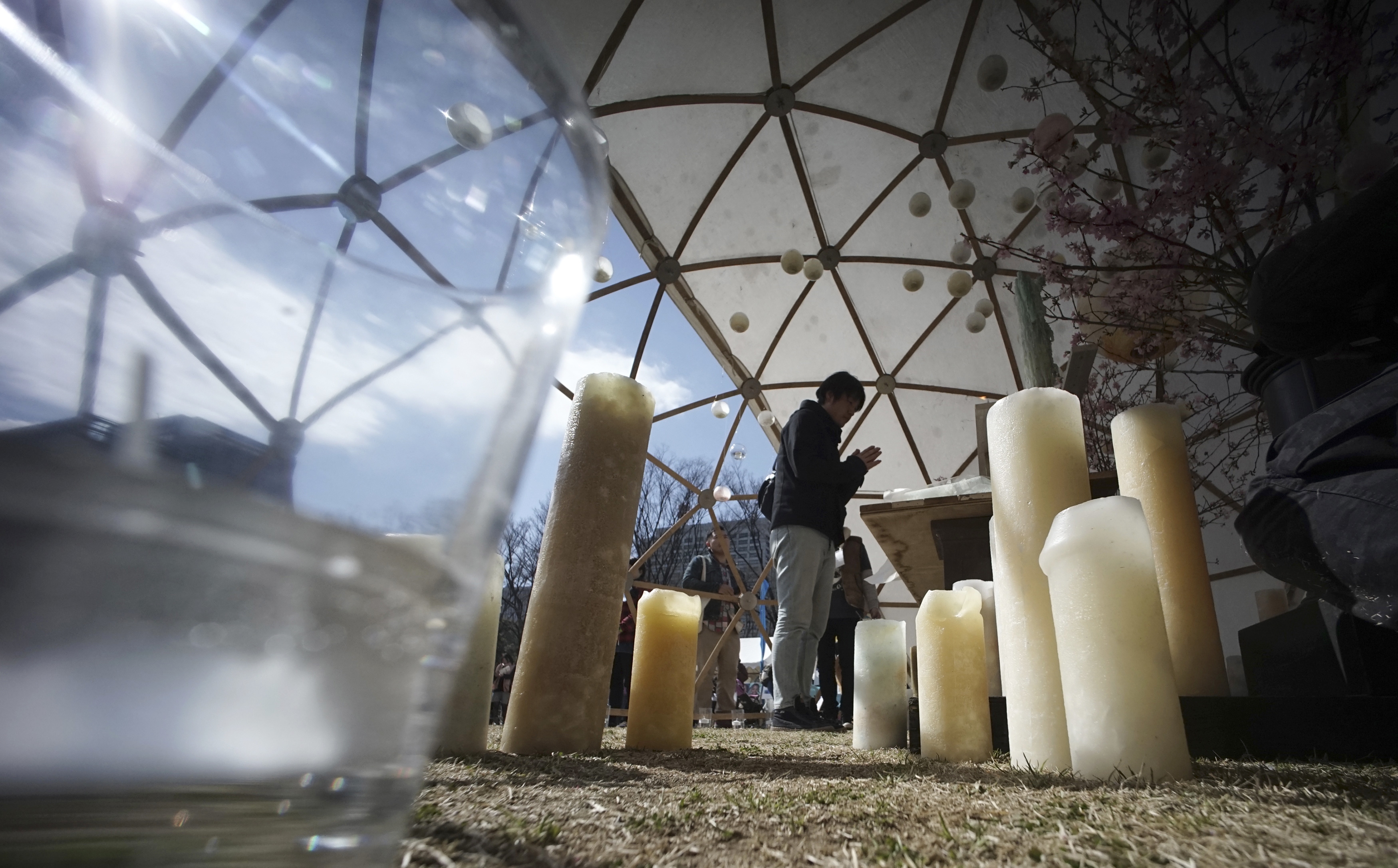 A man prays to mourn for victims of the March 11, 2011 earthquake and tsunami prior to a special memorial event in Tokyo, Saturday, March 11, 2017. Japan on Saturday marked the sixth anniversary of the 2011 tsunami that killed more than 18,000 people and left a devastated coastline along the country's northeast that has still not been fully rebuilt. (AP Photo/Eugene Hoshiko)