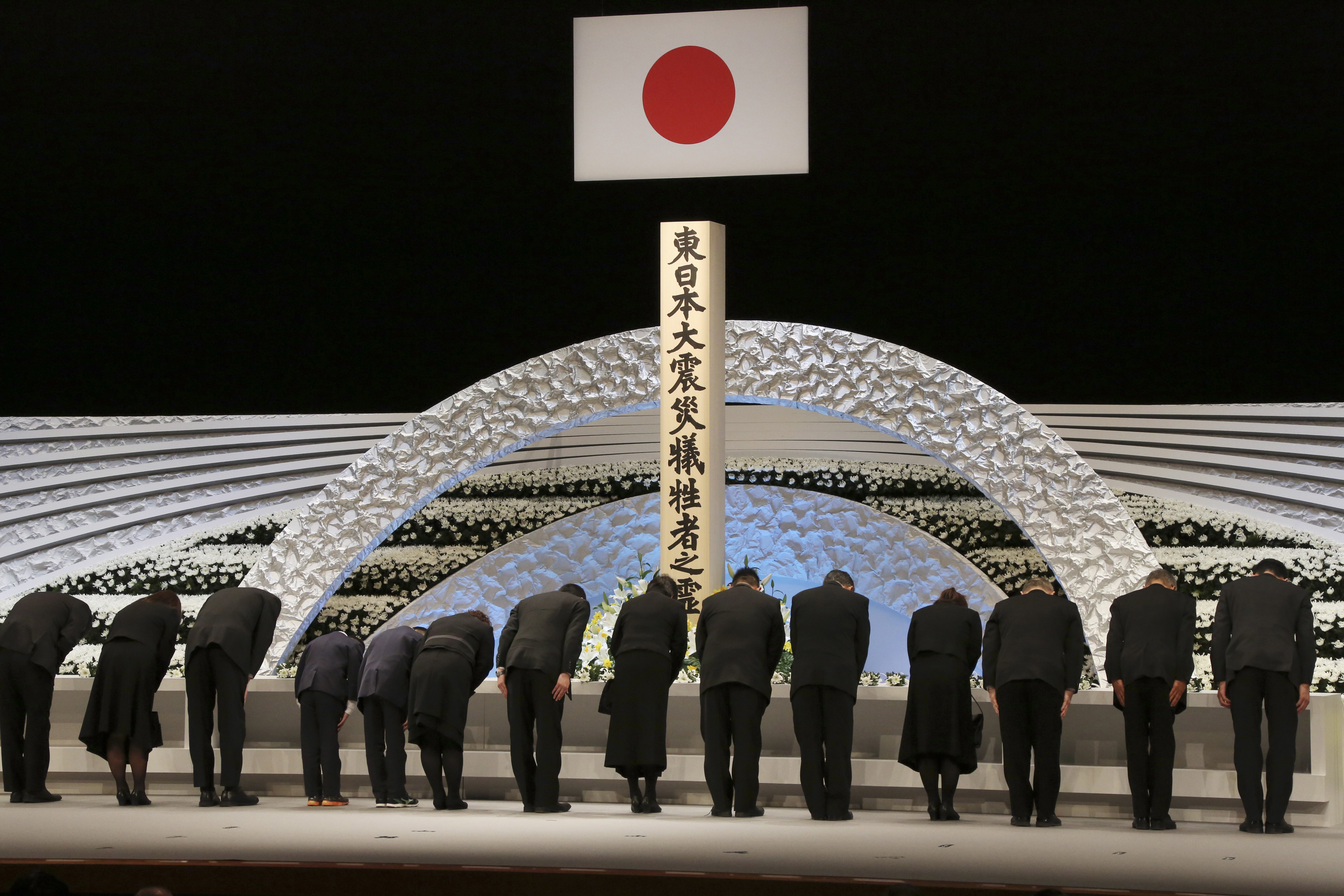 Bereaved family members bow in front of the altar for the victims of the March 11, 2011 earthquake and tsunami during the national memorial service in Tokyo Saturday, March 11, 2017. Japan marks Saturday the sixth anniversary of the 2011 disaster in which more than 18,000 people died or went missing. (AP Photo/Koji Sasahara)Pool