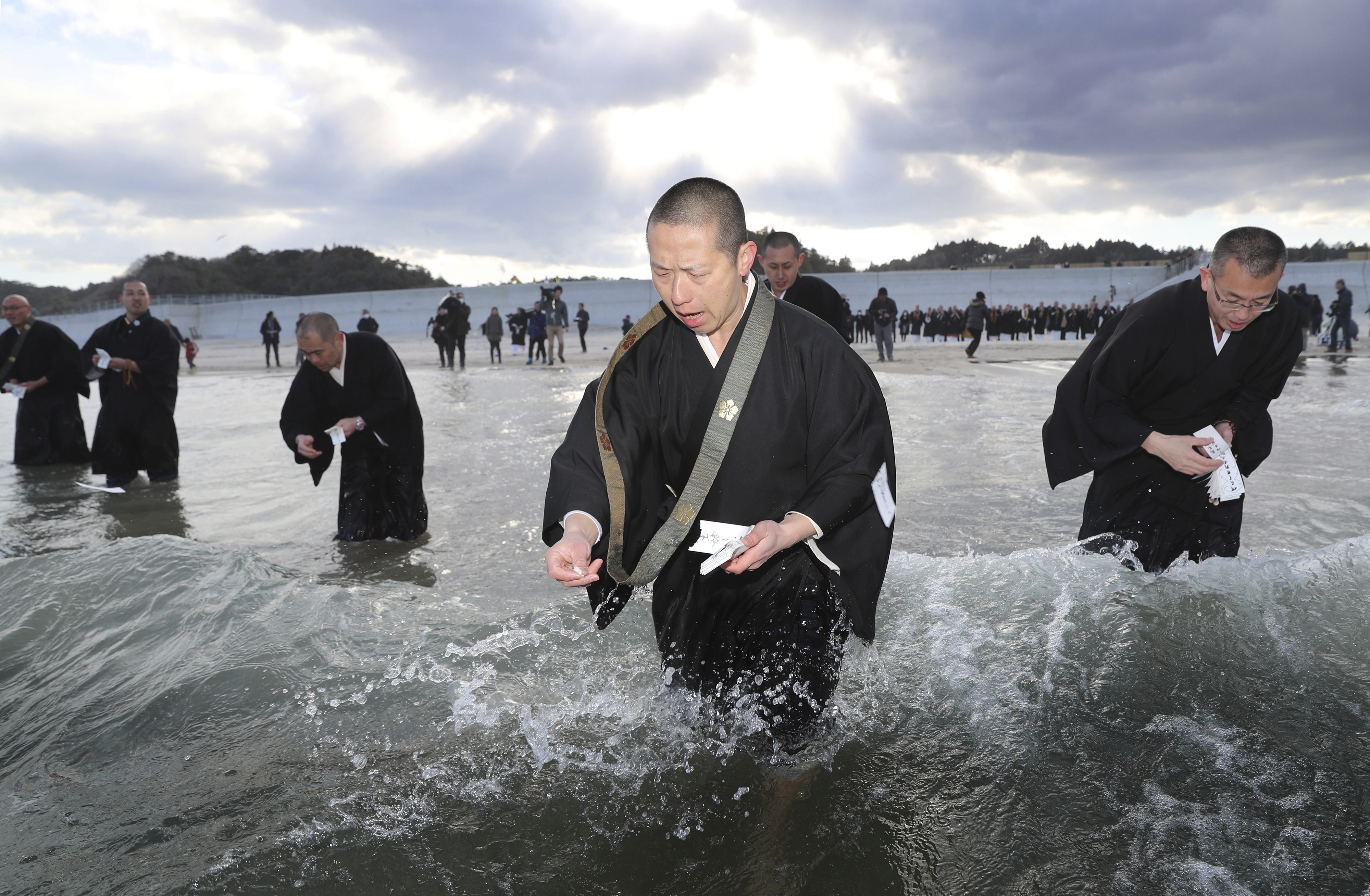 Buddhist monks offer a memorial prayer for the victims at Usuiiso beach in Iwaki,  Fukushima Prefecture  on March 11, 2017,  six years after the meltdwons of the Fukushima No. 1 nuclear power plant triggered by the monstrous tsunami.   ( The Yomiuri Shimbun via AP Images )