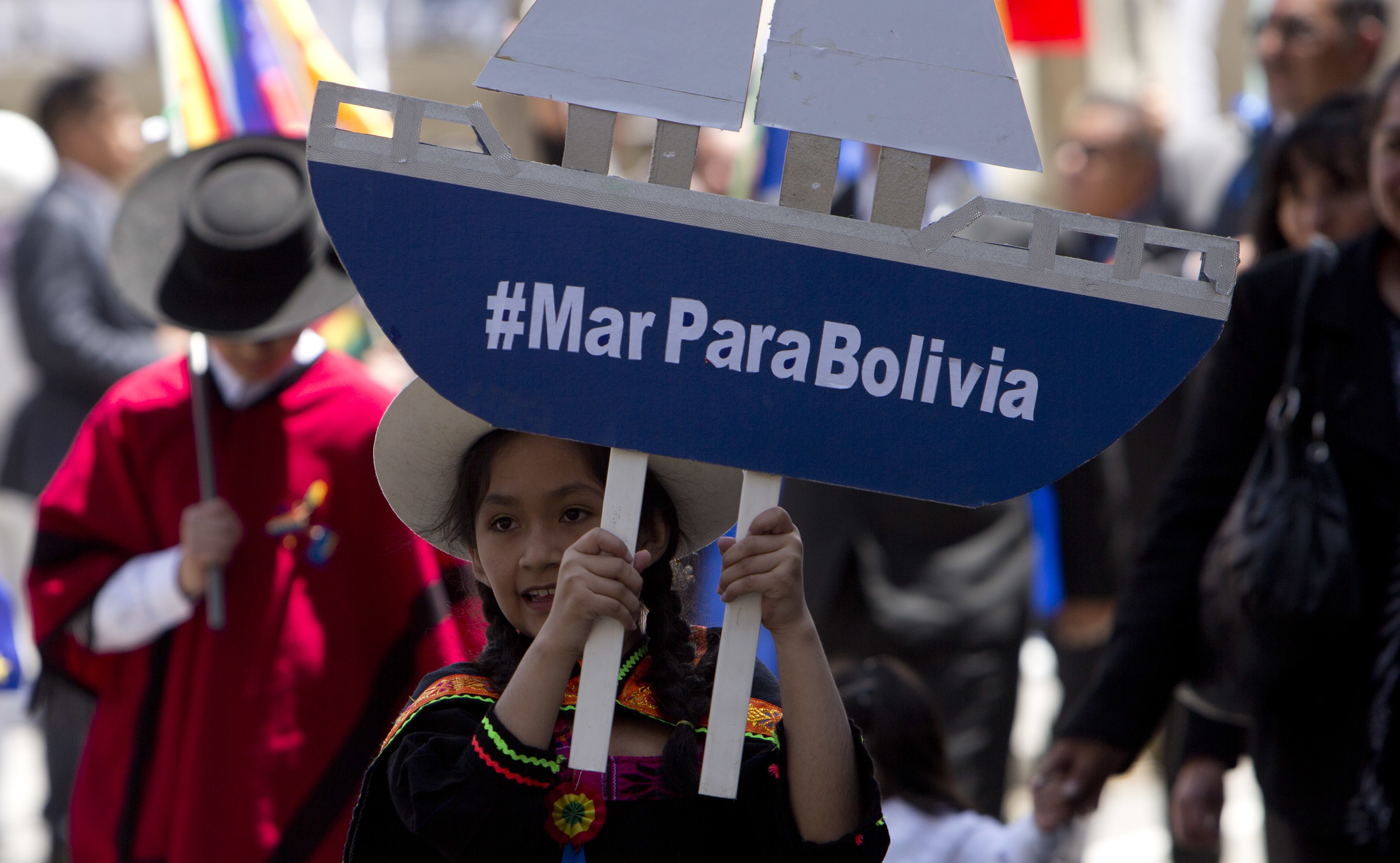A girl holds a paper ship and signs that reads in Spanish "Sea for Bolivia," during an event honoring national hero Eduardo Abaroa, who died in the 1879-1884 War of the Pacific, during Sea Day commemorations in La Paz, Bolivia, Friday, March 23, 2018. Sea Day marks the anniversary of Bolivia losing a 19th century war with Chile, with the subsequent loss of its Pacific coastline. The International Court of Justice in The Hague is holding public hearings in the case concerning the obligation to negotiate access to the Pacific Ocean between both countries. (AP Photo/Juan Karita)