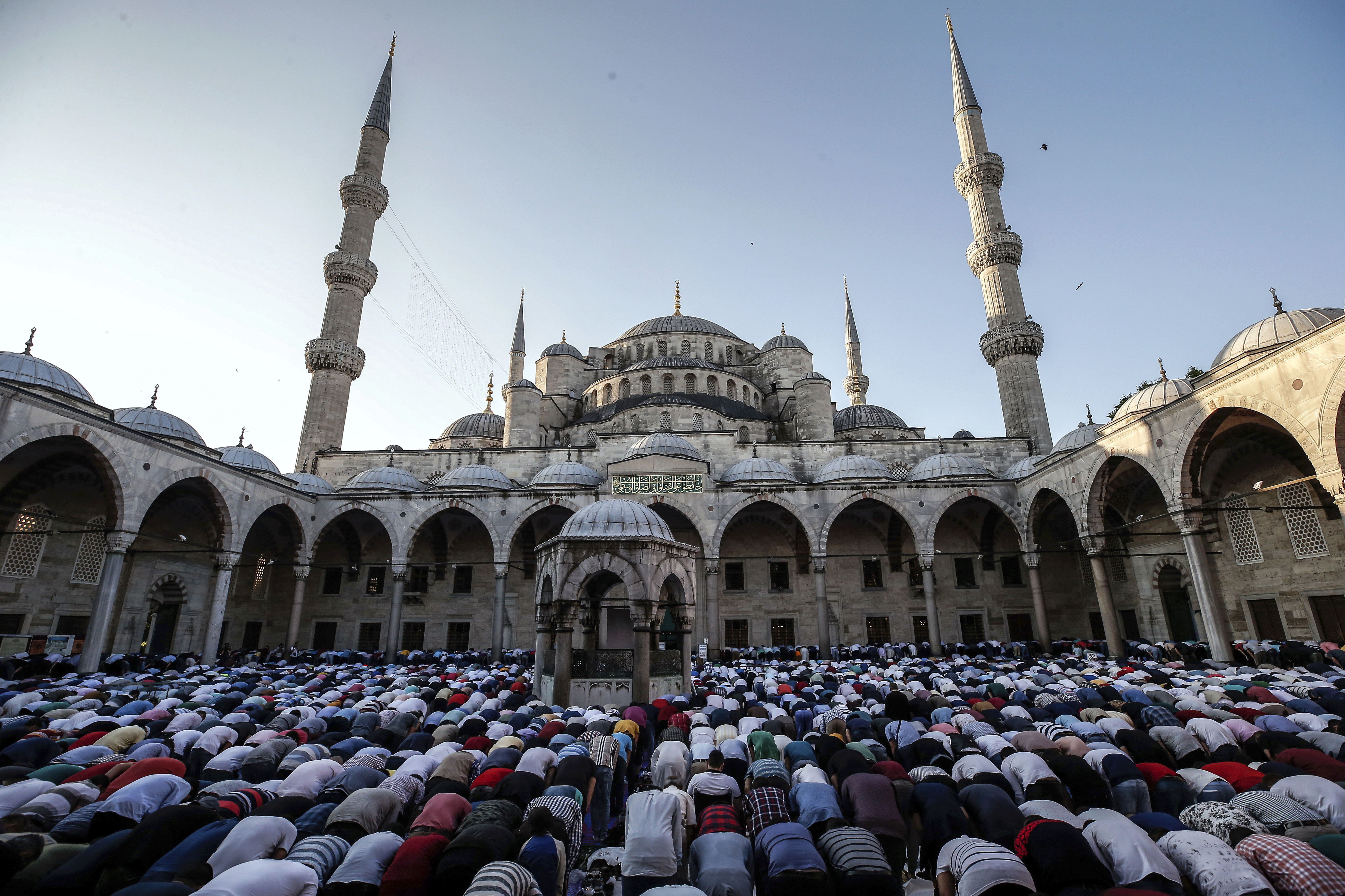 Turkish Muslims offer Eid al-Fitr prayers at the city's landmark Sultan Ahmed Mosque, or Blue Mosque, in Istanbul, early Sunday, June 25, 2017. Eid al-Fitr marks the end of the Muslims' holy fasting month of Ramadan. (AP Photo/Emrah Gurel)