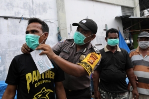 Indonesia authorities distribute face masks to residents over haze from fires in Indonesia