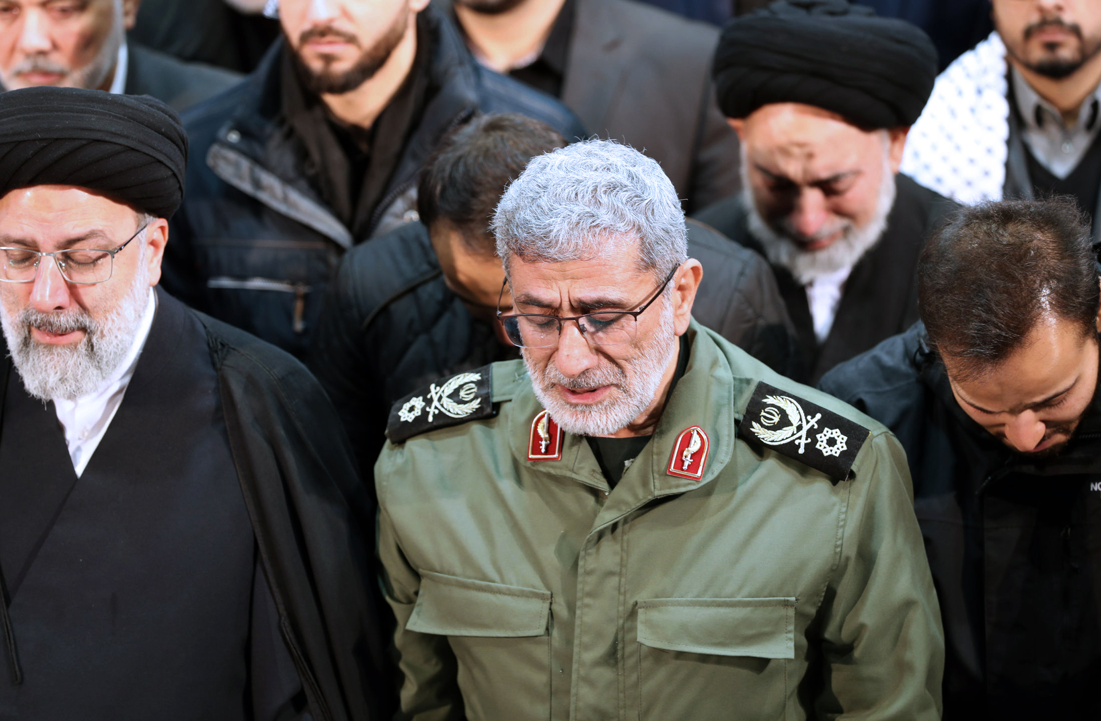 In this photo released by the official website of the Office of the Iranian Supreme Leader, Gen. Esmail Ghaani, newly appointed commander of Iran's Revolutionary Guards Quds Force, weeps while praying over the coffin of the force's previous head Gen. Qassem Soleimani at the Tehran University Campus in Tehran, Iran, Monday, Jan. 6, 2020. Soleimani was killed Friday, Jan. 3 in a U.S. drone attack in Iraq. (Office of the Iranian Supreme Leader via AP)