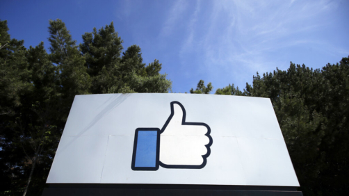 FILE - In this April 14, 2020 file photo, the thumbs up Like logo is shown on a sign at Facebook headquarters in Menlo Park, Calif. Social media and other internet companies face big fines in Britain if they don't limit the amount of harmful material such as child sexual abuse or terrorist content on their platforms, officials said Tuesday, Dec. 15, 2020. (AP Photo/Jeff Chiu, File)