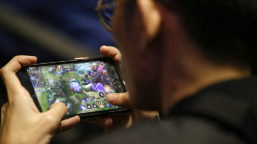 In this Thursday, Aug. 29, 2019, photo, an esport (electronic sport) player plays on his smartphone during the qualifying rounds for the first Philippine esport team in metropolitan Manila, Philippines. Esports, a form of competition using video games, will be making its debut as a medal sport at the 30th South East Asian Games in the country which starts November this year. (AP Photo/Aaron Favila)