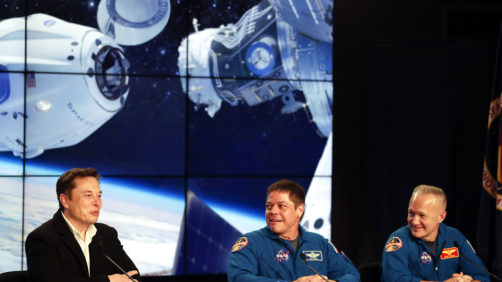 FILE - In this Saturday, March 2, 2019 file photo, Elon Musk, left, CEO of SpaceX, speaks accompanied by NASA astronauts Bob Behnken, center, and Doug Hurley during a news conference after the SpaceX Falcon 9 Demo-1 launch at the Kennedy Space Center in Cape Canaveral, Fla. (AP Photo/John Raoux)